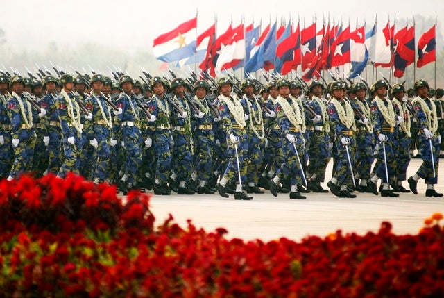 Burma's soldiers carry their weapons as they march during the Armed Forces Day parade in Burma's capital Naypyidaw on March 27, 2010.