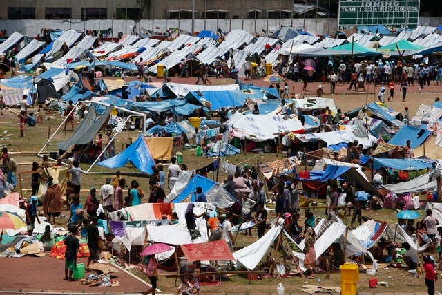 Evacuees displaced during fighting between government soldiers and the Moro National Liberation Front (MNLF) stay in makeshift shelters in Zamboanga City on September 20, 2013.