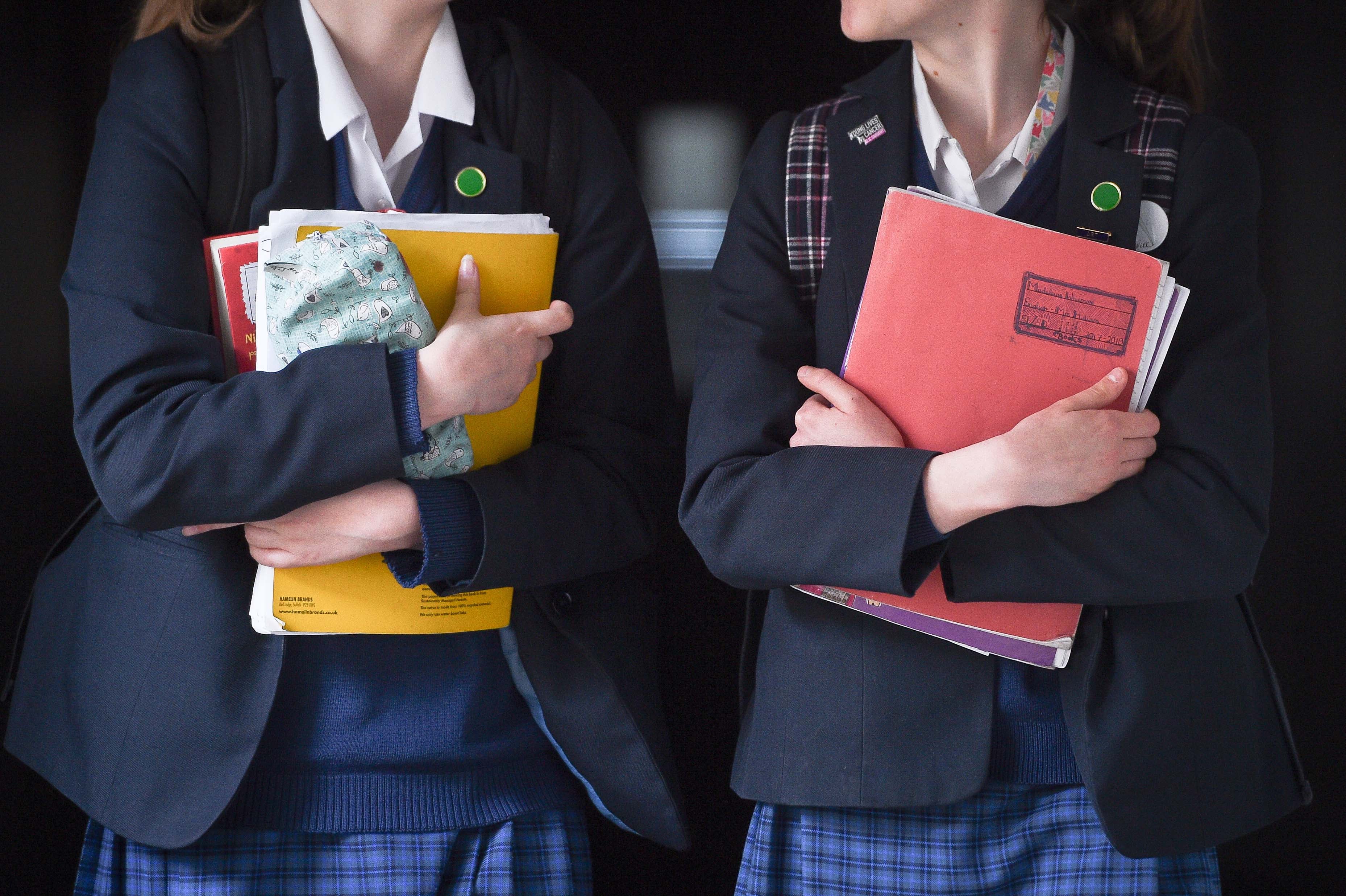 Students walk along a corridor at a school for girls in the U.K. that offers the International Baccalaureate program.