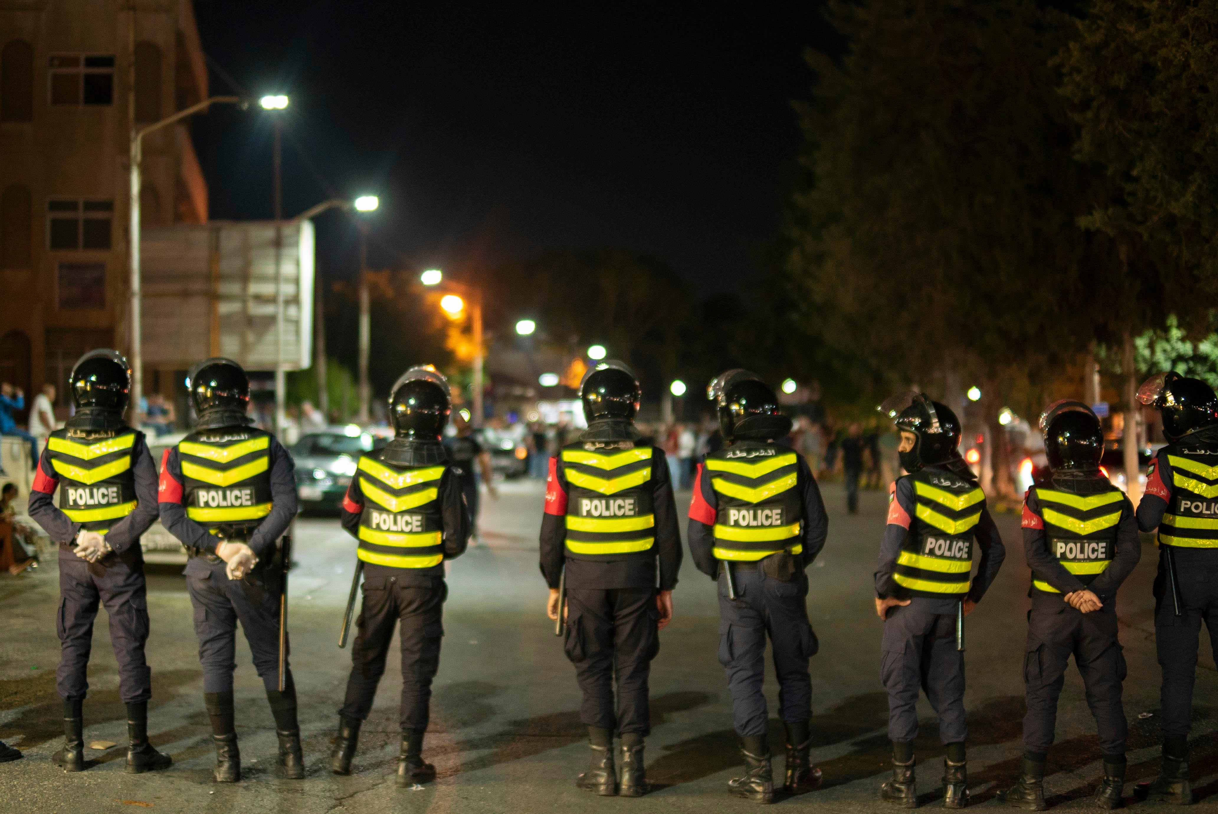  Jordanian police block a road in front of protestors in Irbid, north of Jordan on August 1, 2020.