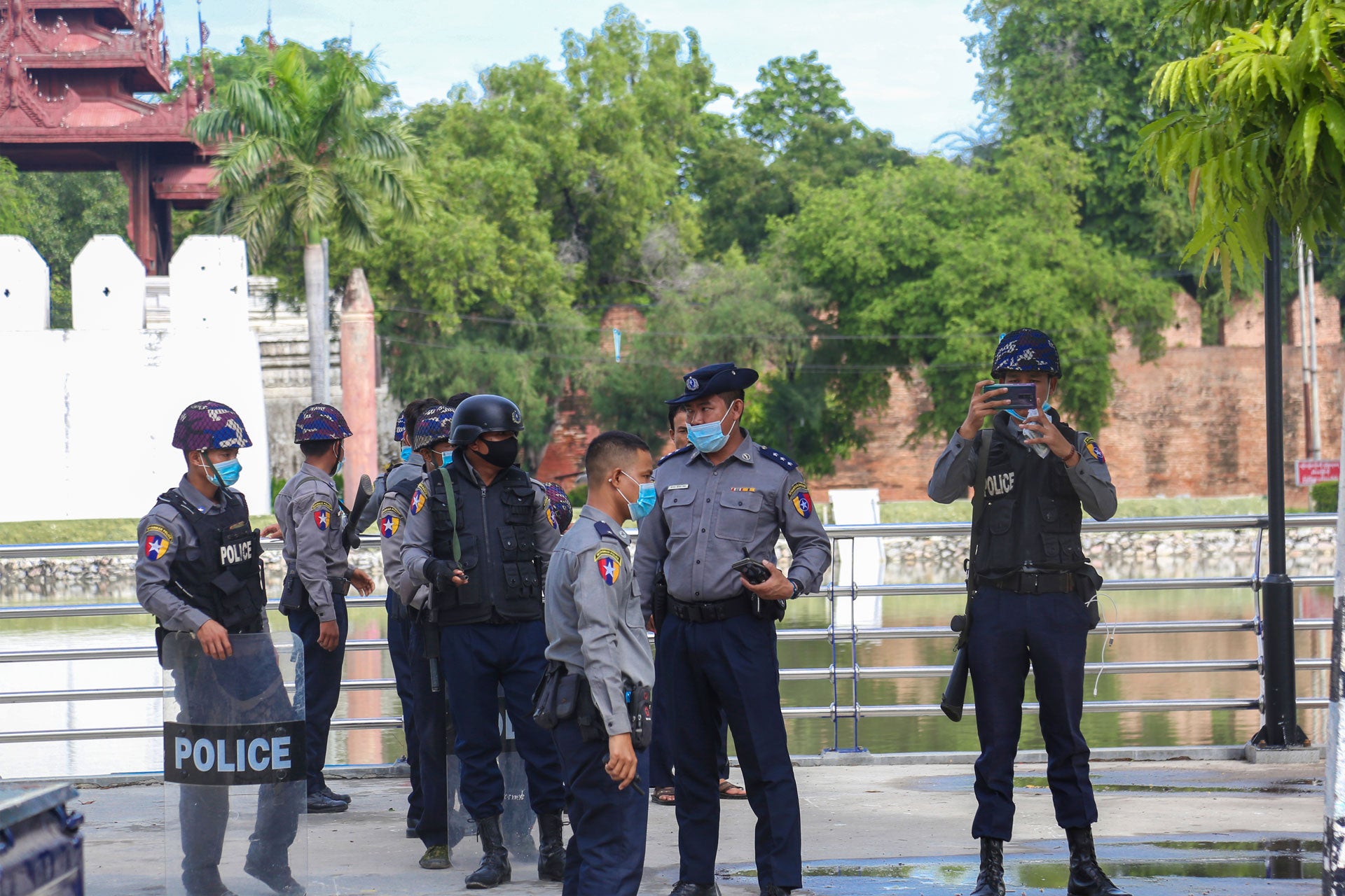 Police officers wearing facemasks stand on a street in Yangon, Myanmar, November 3, 2020. 