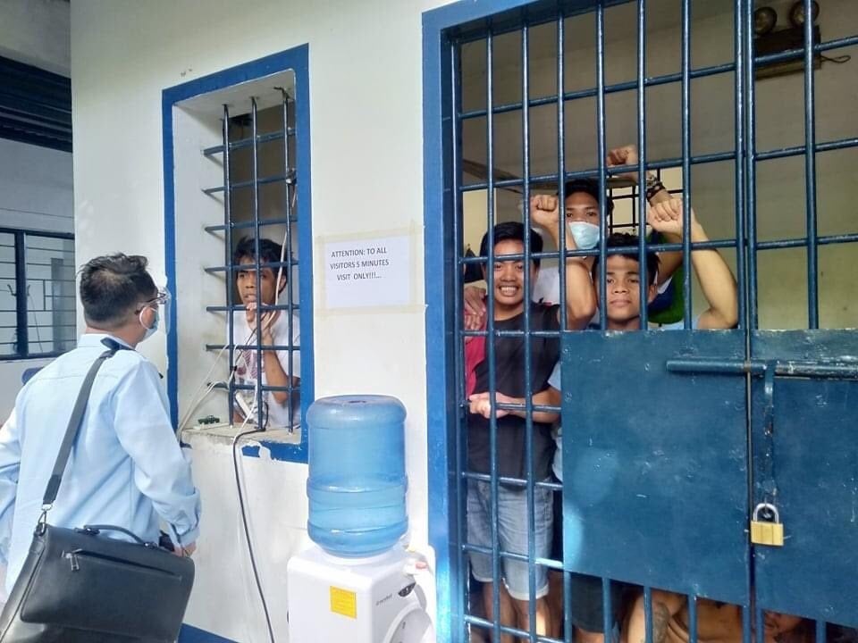 Arrested teachers and adult Indigenous students confer with their lawyer while detained in a Cebu City jail. 