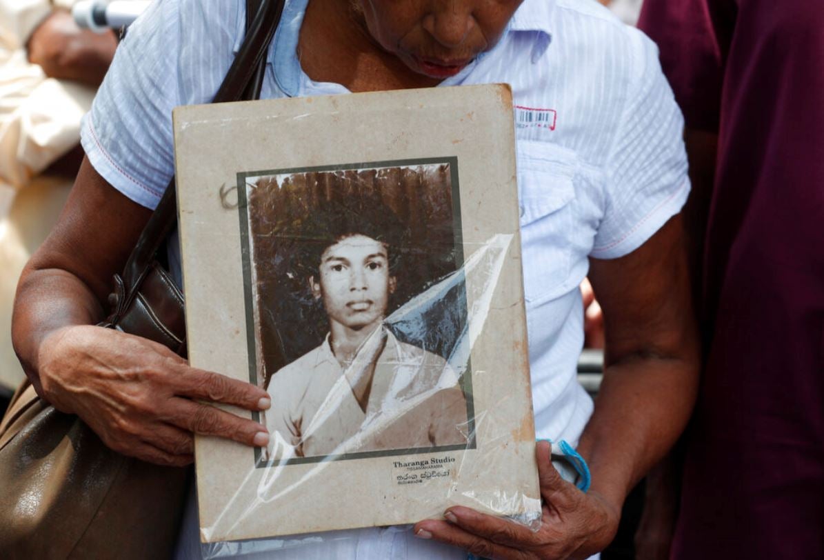 A Sri Lankan woman holds a portrait of a relative who went missing, during a protest in Colombo, Sri Lanka,  February 14, 2020.