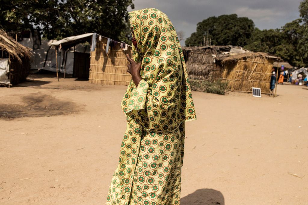 A woman walks through the Internally Displaced Person camp "25 de junho," in Metuge, Mozambique on May 20, 2021. 