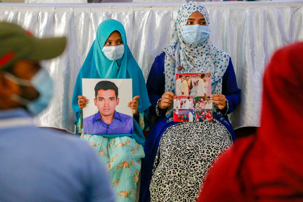 Children hold the picture of their fathers as they join in an event to mark the International Day of the Disappeared in Dhaka, Bangladesh on August 30, 2021.