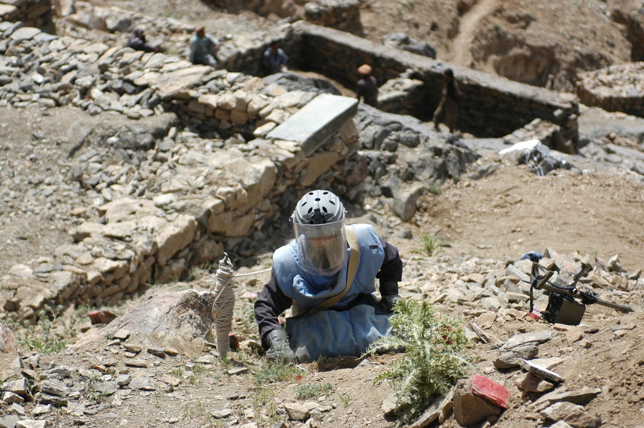 Clearance operator from the Halo Trust clearing a steep, rocky hillside in Afghanistan.