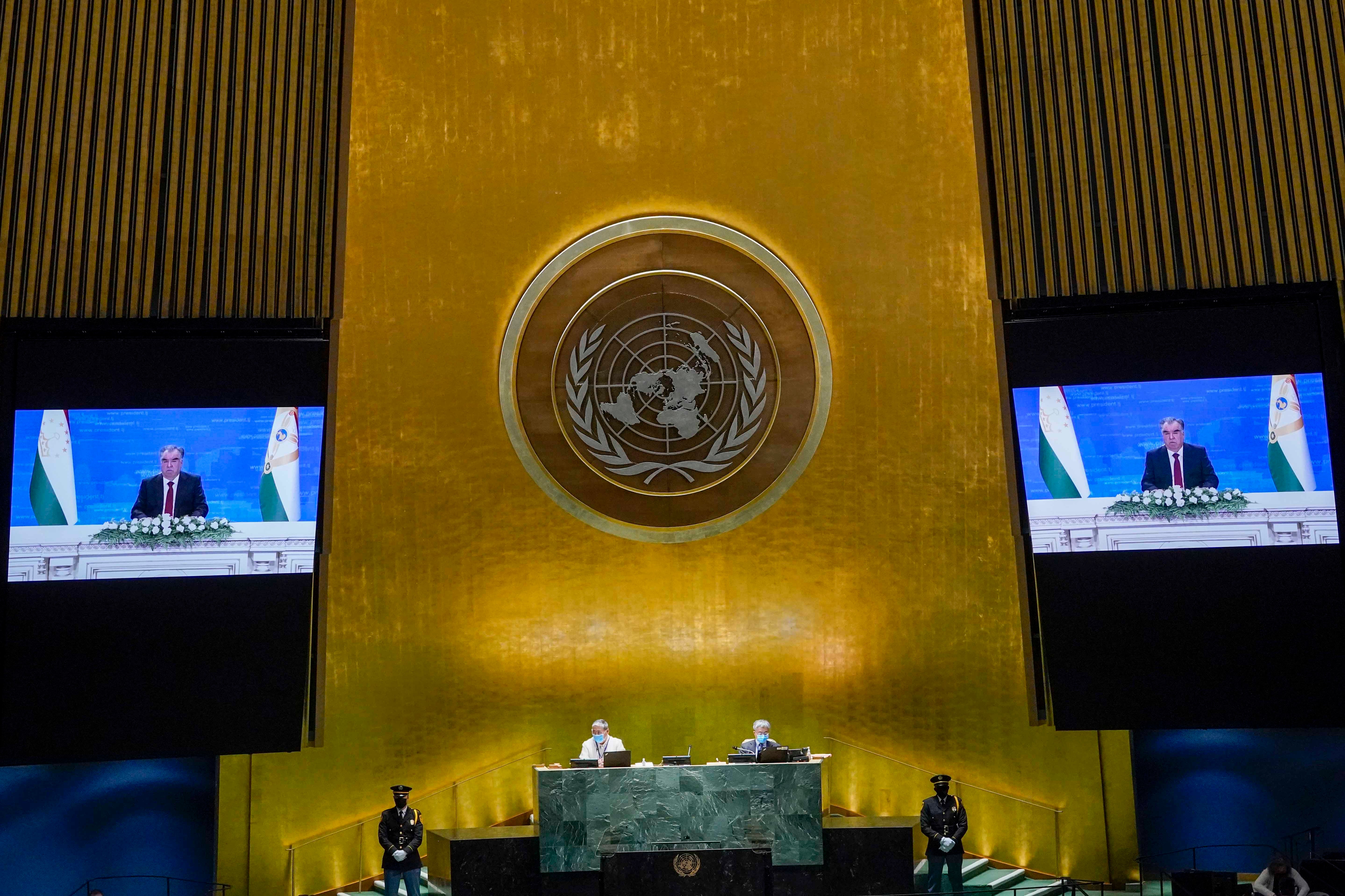 A man on two video screens in the UN general assembly hall