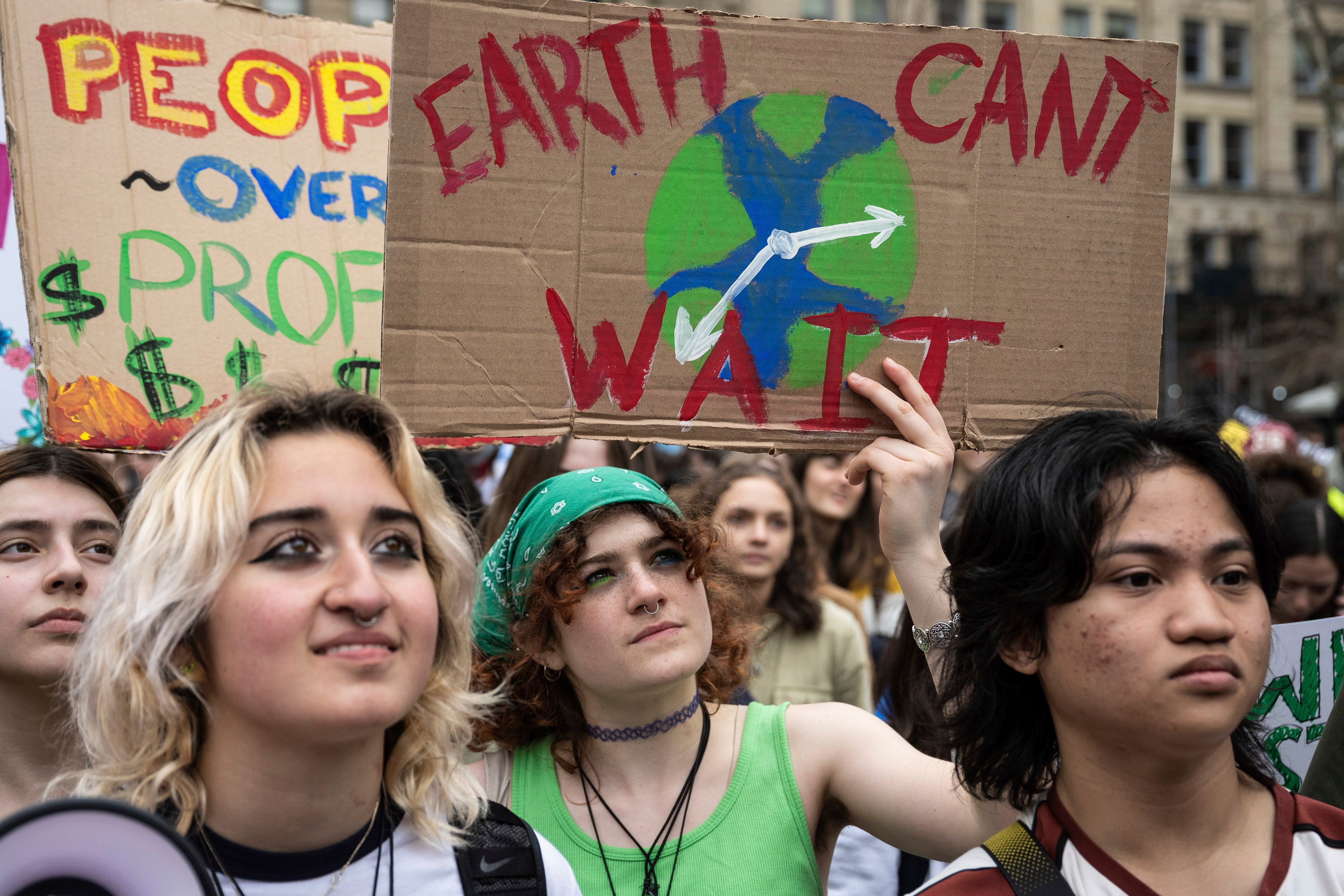 People at a protest holding handmade signs