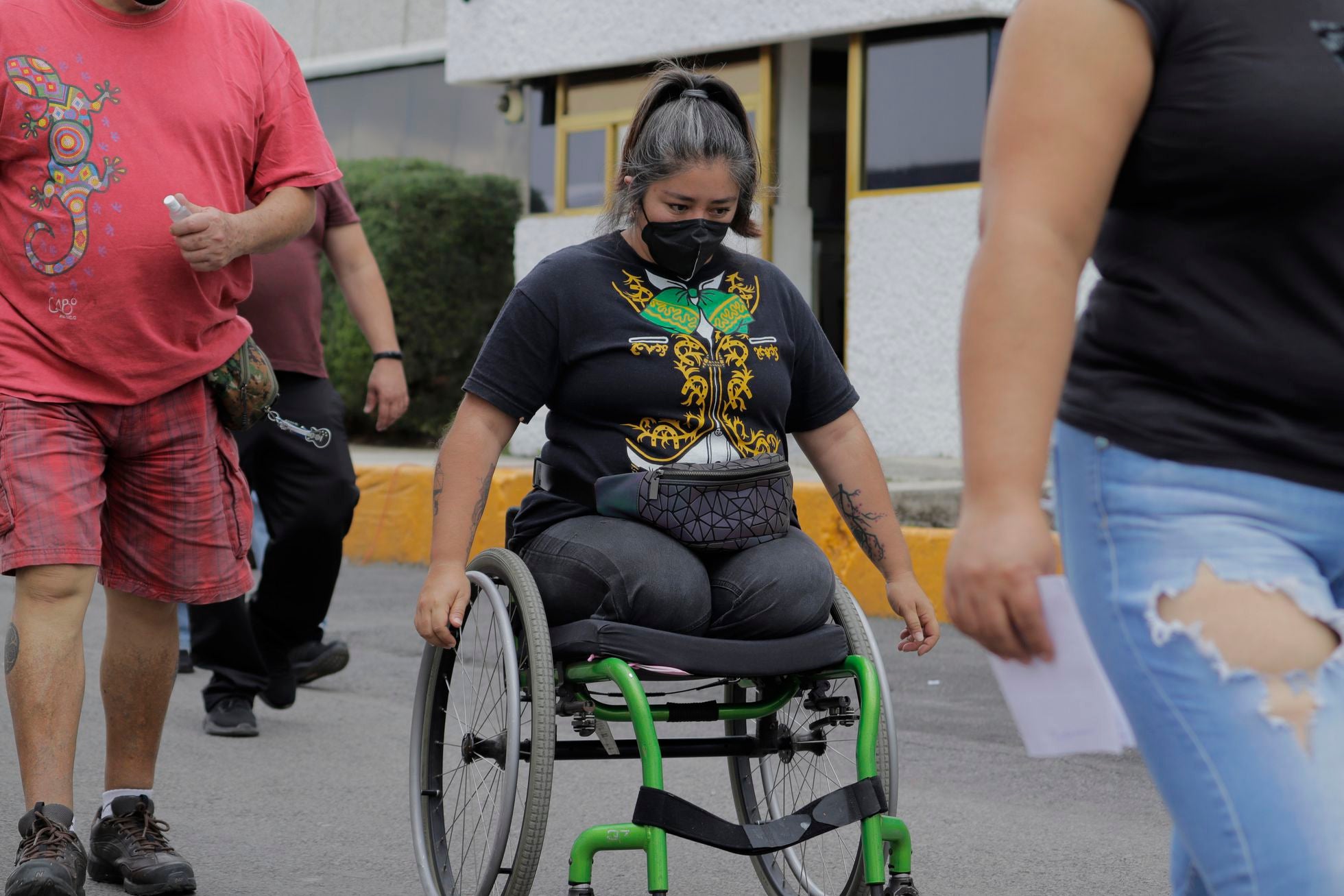 A woman with a disability moves in her wheelchair in a street in Iztapalapa, Mexico City, in June 2021.