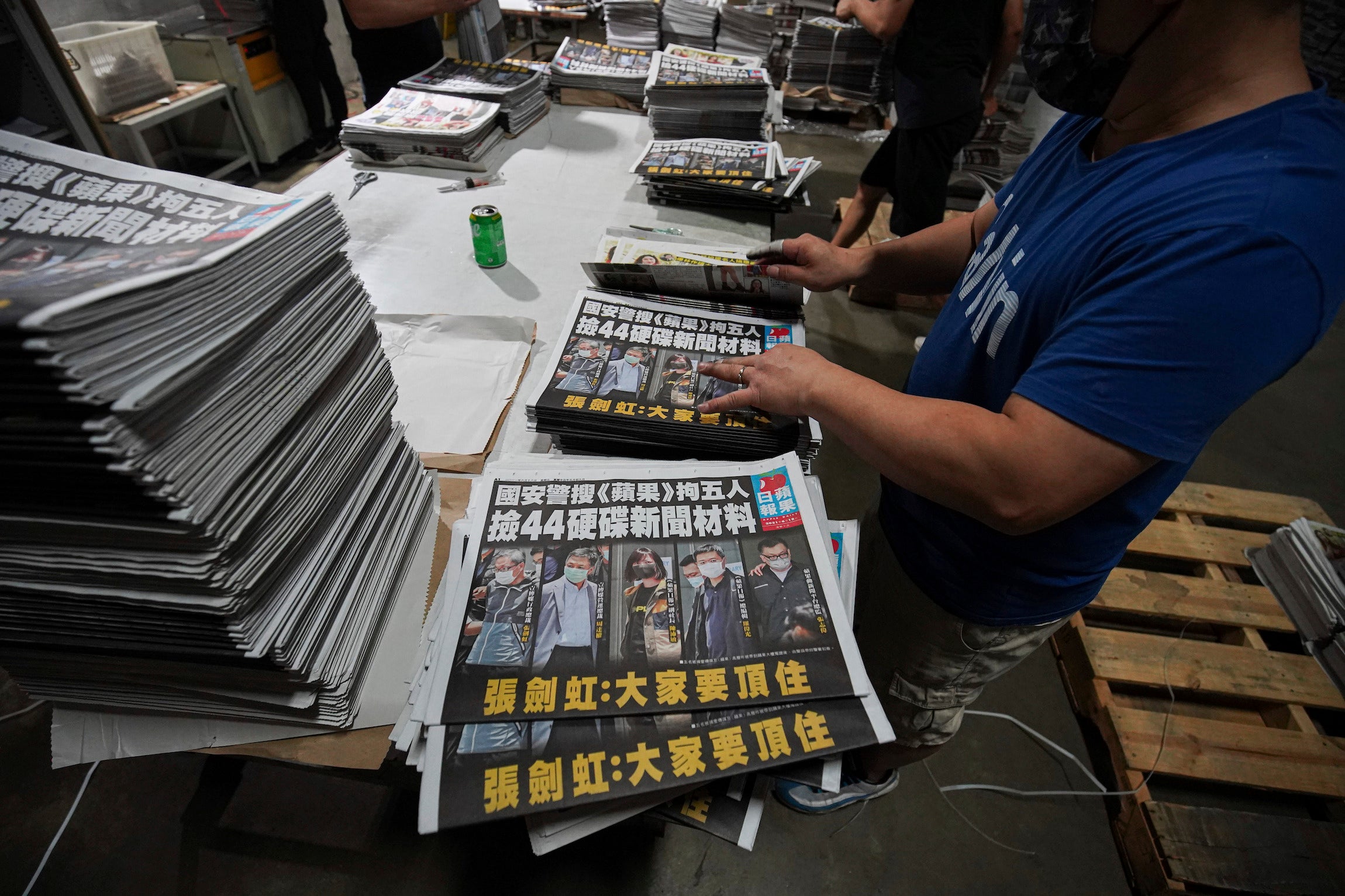 Workers pile Apple Daily newspapers at the printing factory in Hong Kong.