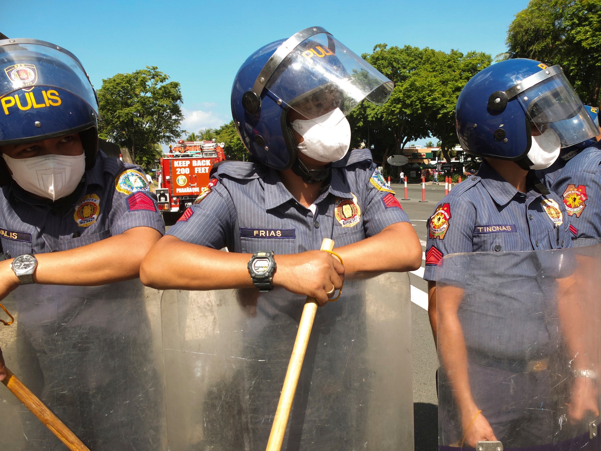 Philippine police officers with batons during a demonstration by youth group activists in Manilla,