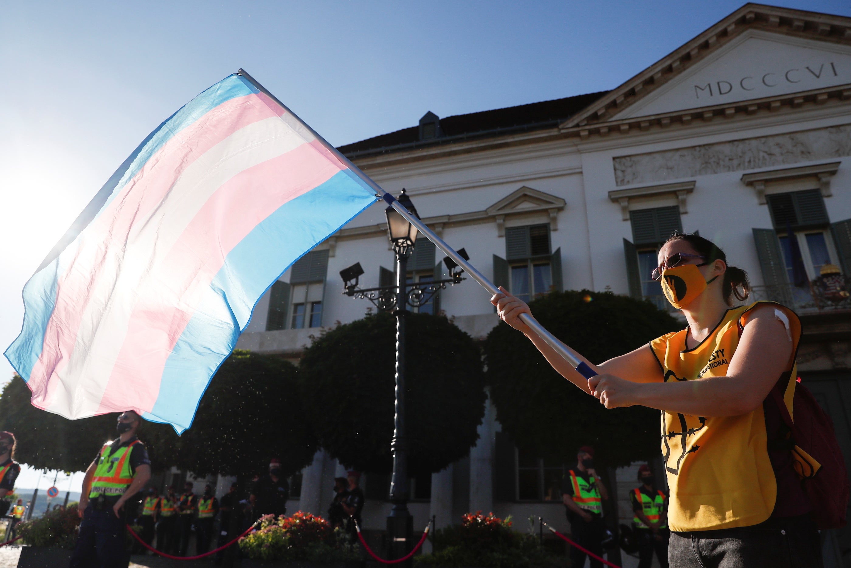 An activist waves the transgender flag during a protest at the Presidential Palace in Budapest.