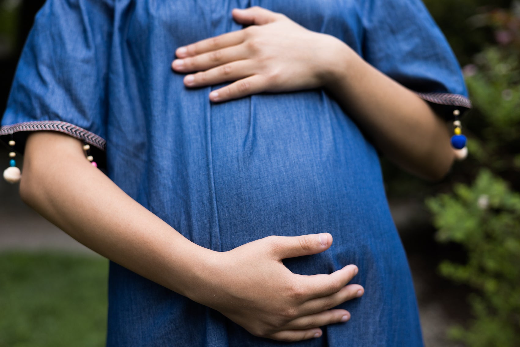 Pregnant woman holding her belly. 