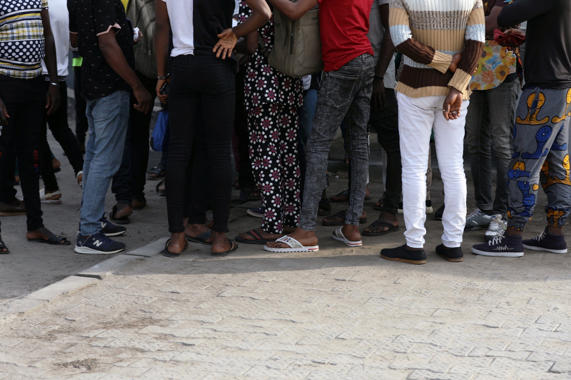 Men charged with public displays of same-sex affection gather within the premises of the Federal High Court in Lagos, Nigeria, March 3, 2020. 