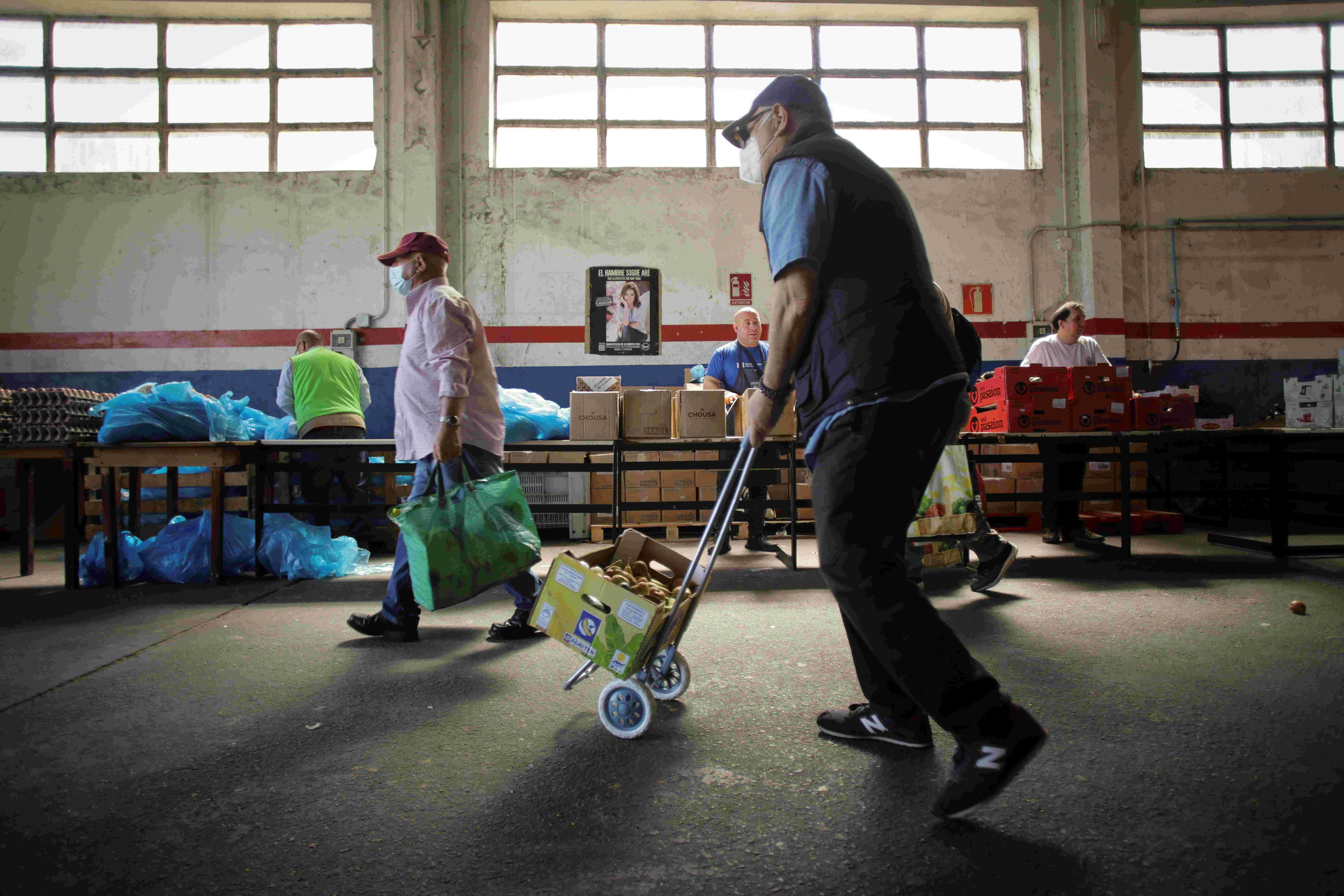 Volunteers attend to people at the Food Bank of Lugo, May 2, 2023, in Lugo, Galicia, Spain.
