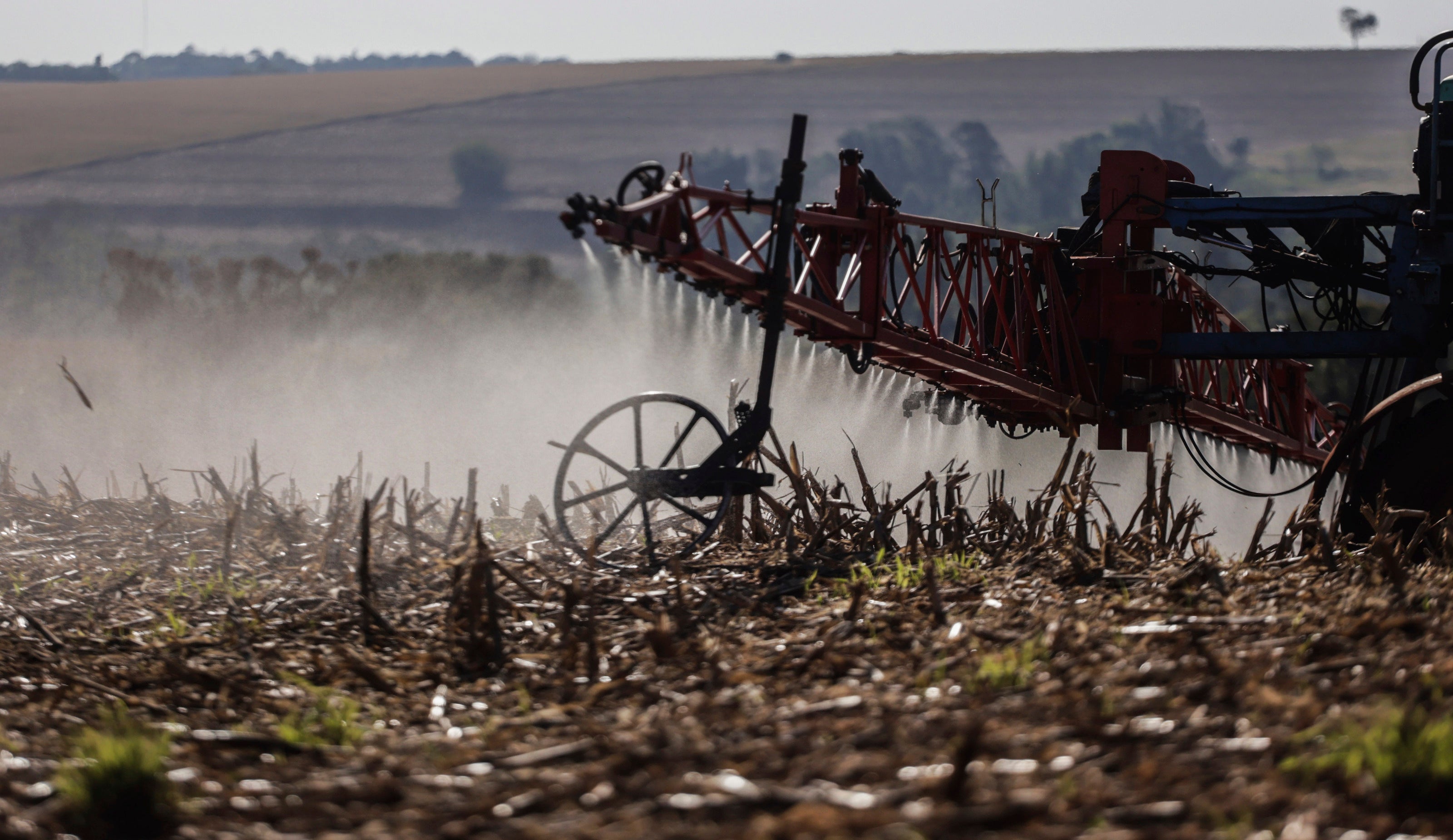 A worker applies fungicide after harvesting a soybean crop in the Central-West Region of Paraná, Brazil, September 16, 2023