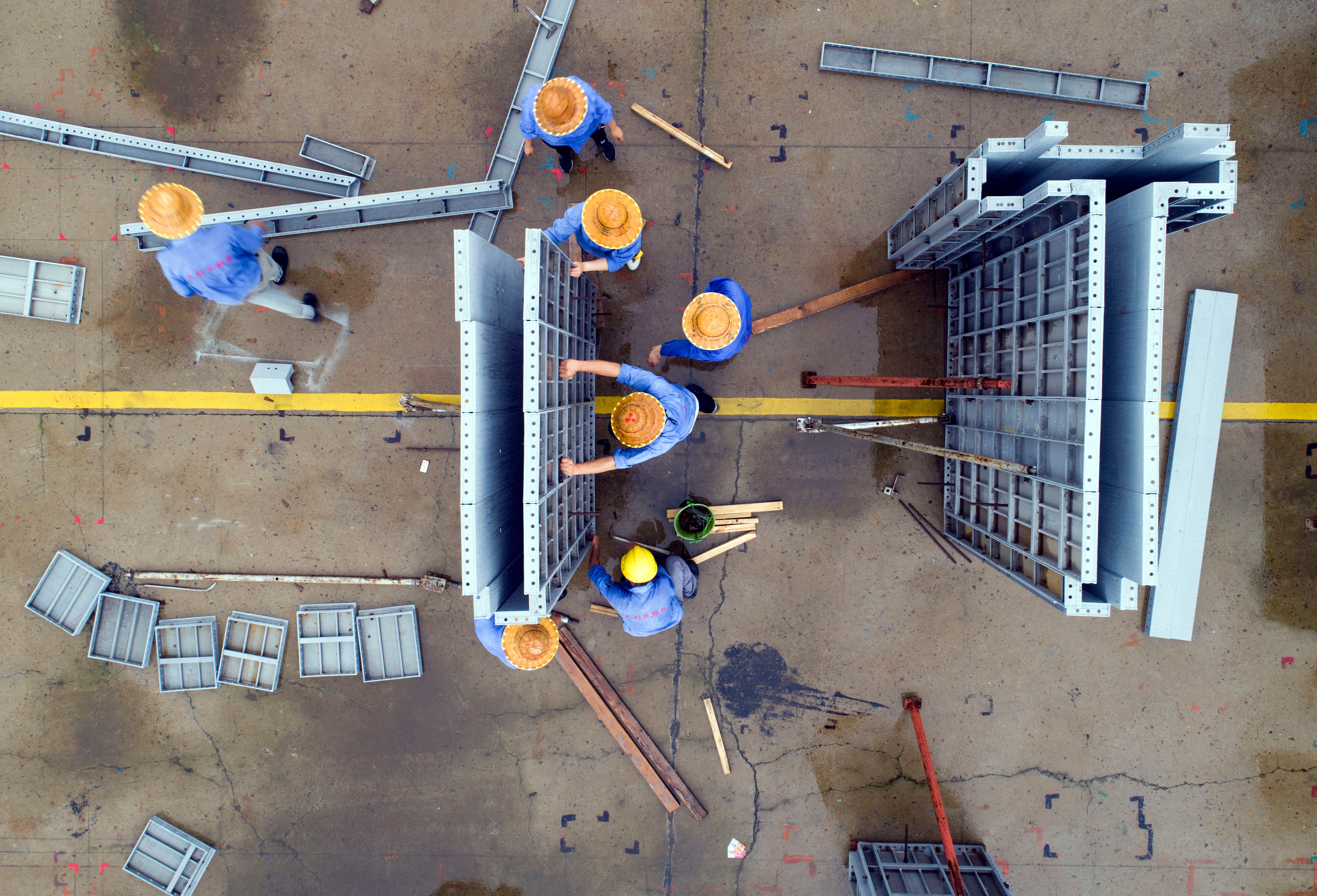 Workers make aluminum alloy products on a production line in Jinhu county, Jiangsu province, China, July 19, 2020.