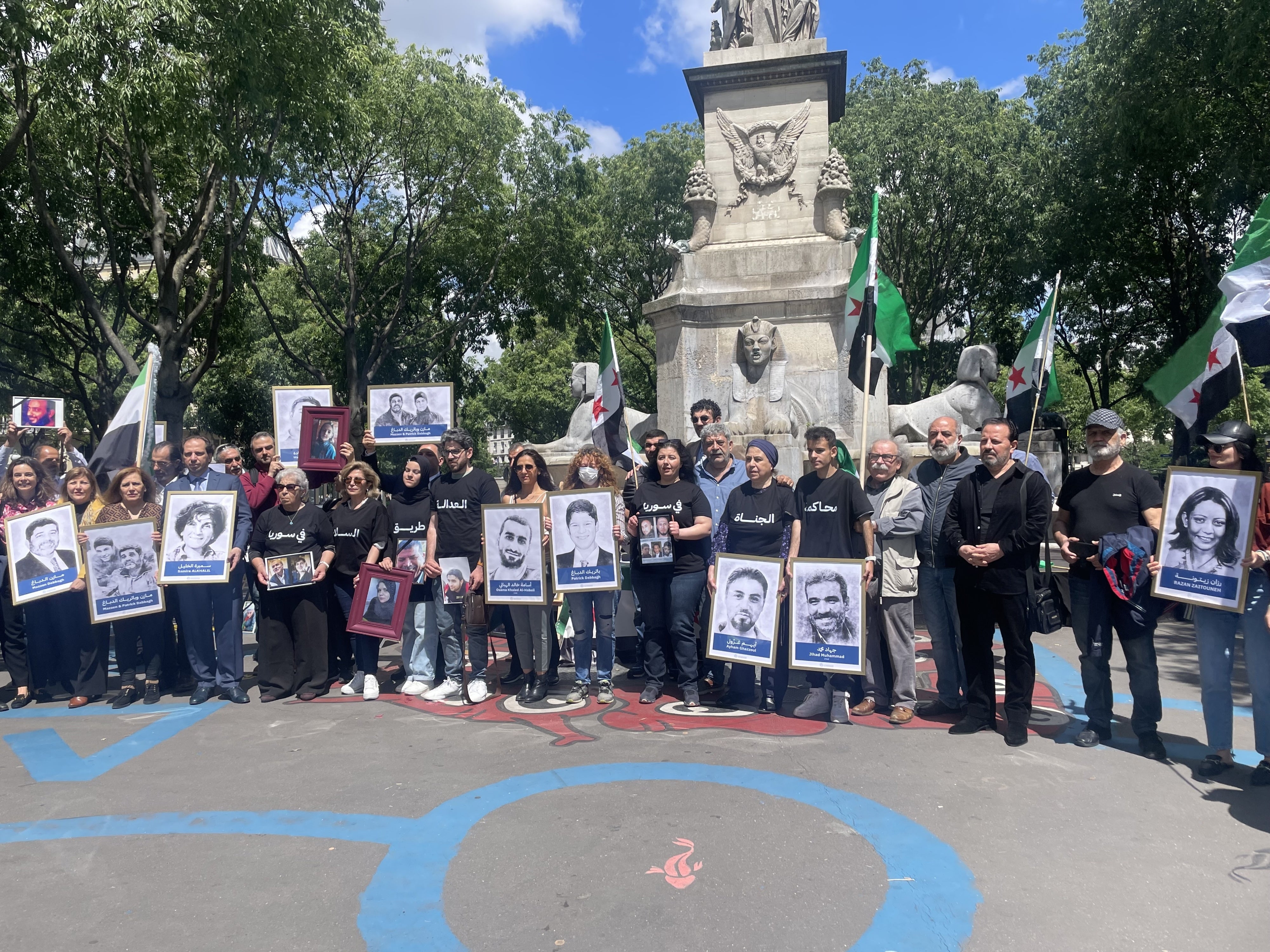 Victims’ and families’ associations gathered next to the Paris Criminal Court on May 21, 2024, holding photos of relatives who have been detained or disappeared in Syria. 