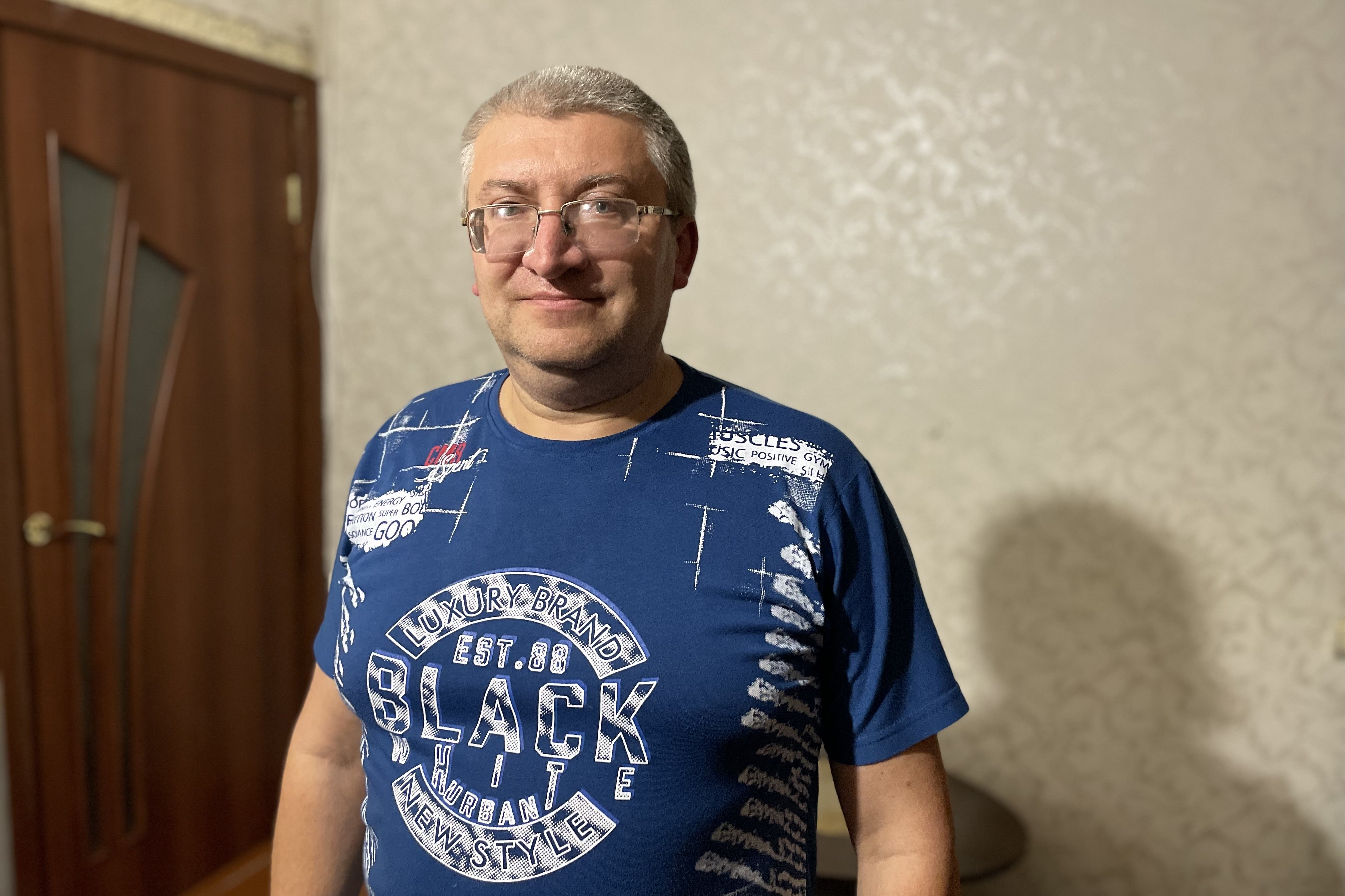 An older man poses for a photo