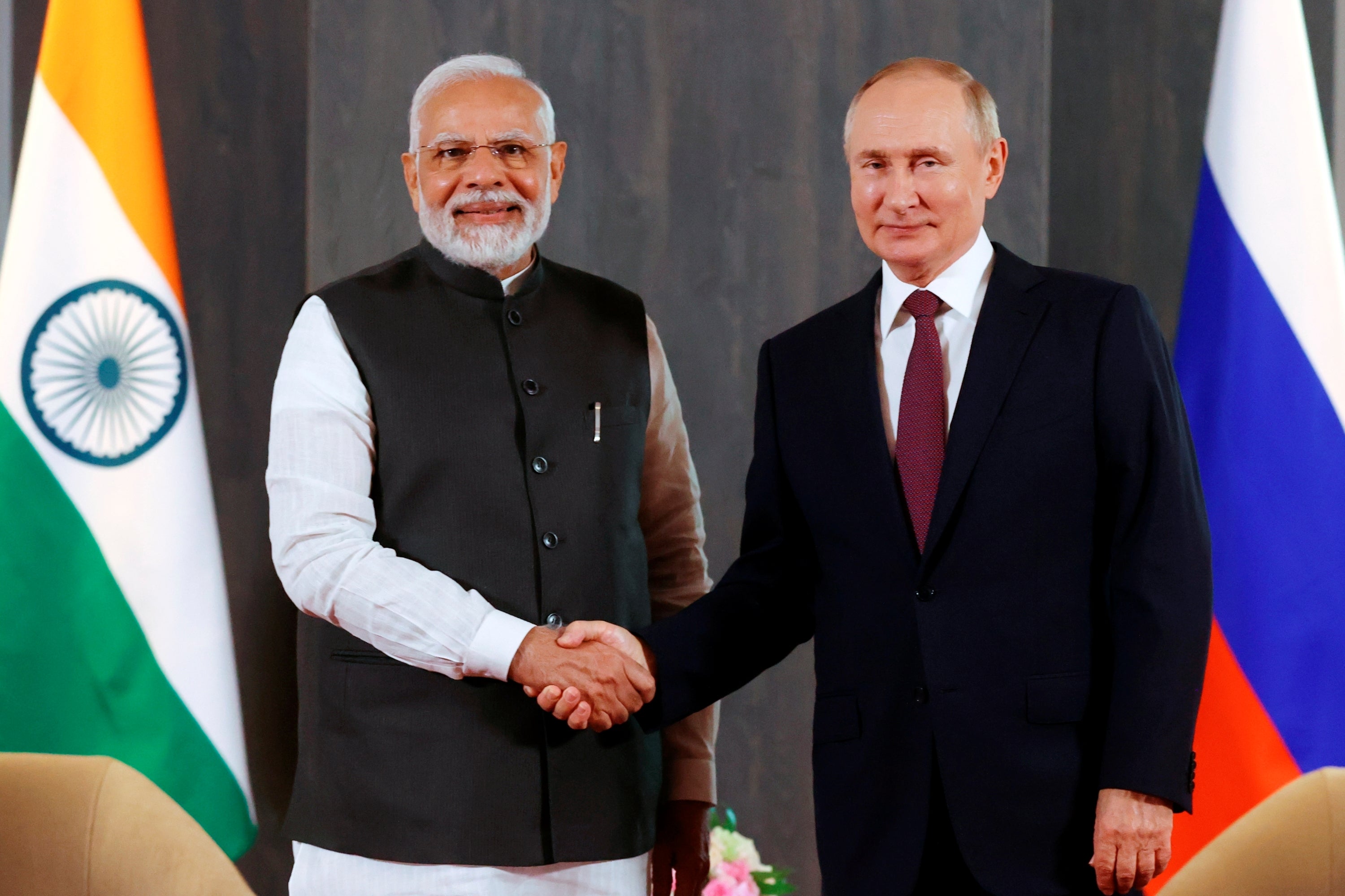 Russian President Vladimir Putin, right, and Indian Prime Minister Narendra Modi pose for a photo shaking hands prior to their talks on the sidelines of the Shanghai Cooperation Organisation (SCO) summit in Samarkand, Uzbekistan, on Sept. 16, 2022.
