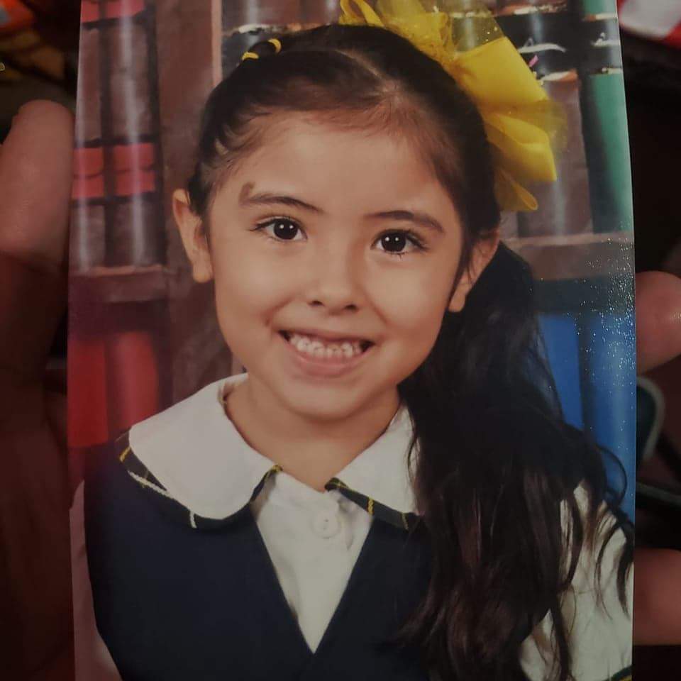 Young girl smiling in a school uniform