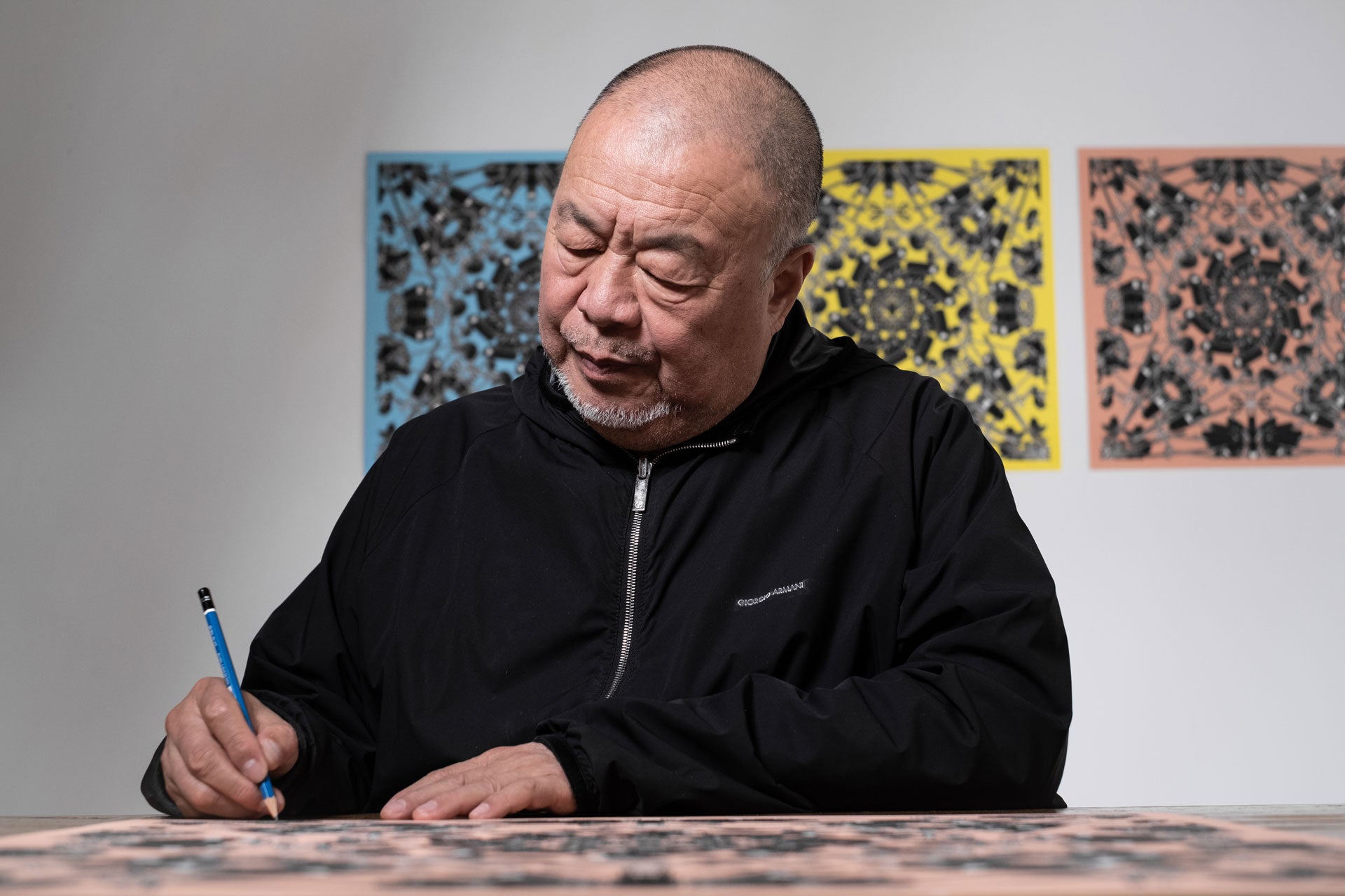 Artist Ai Wei Wei signs a lithograph print