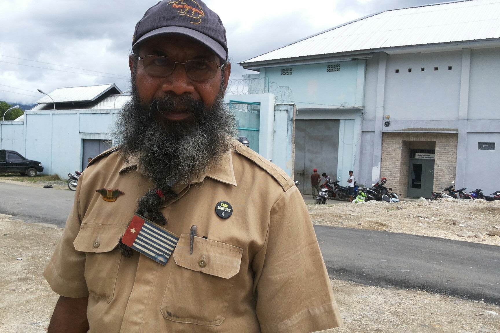 A man poses for a photo in front of a prison
