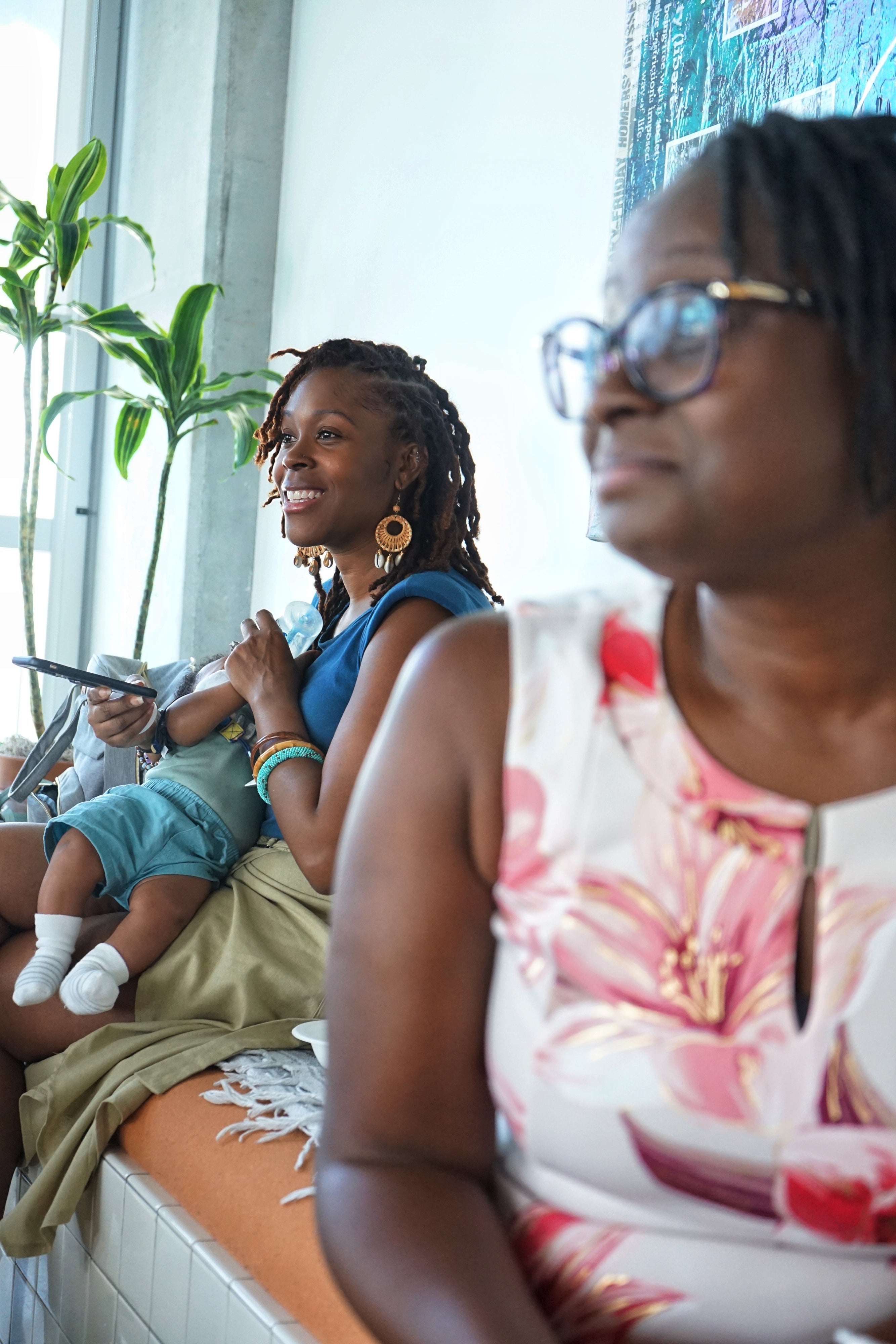 A woman feeds her baby son with a bottle
