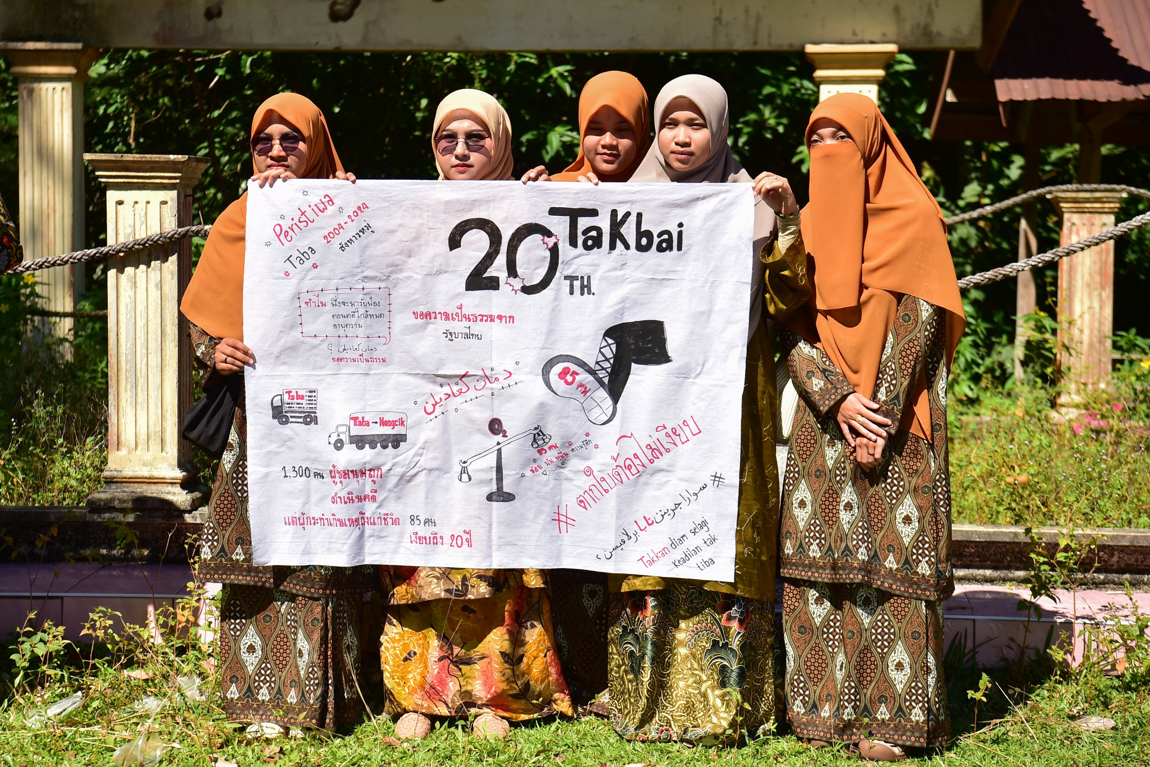 Community members call for justice at a mass grave for victims of the October 2004 Tak Bai massacre, Narathiwat, Thailand, October 25, 2024.