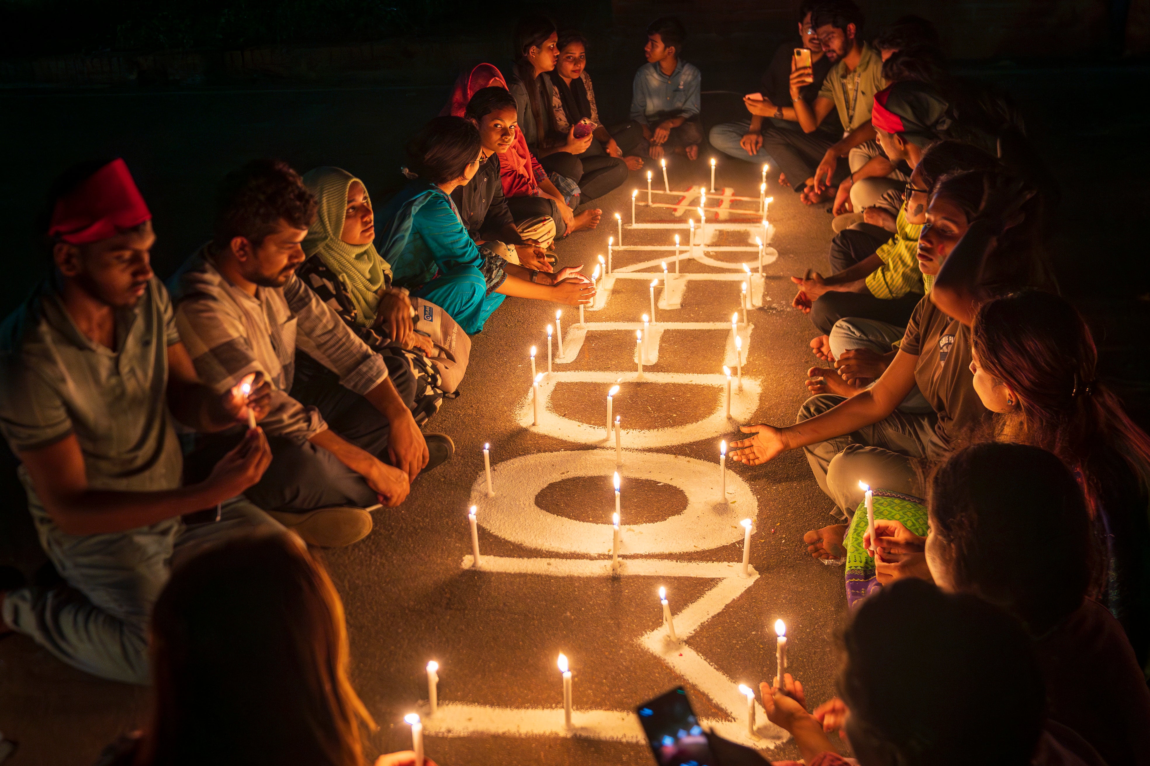 People light candles in front of the national parliament to pay tribute to the students who were killed during protests calling for the resignation of the Hasina government, Dhaka, Bangladesh, August 8, 2024.