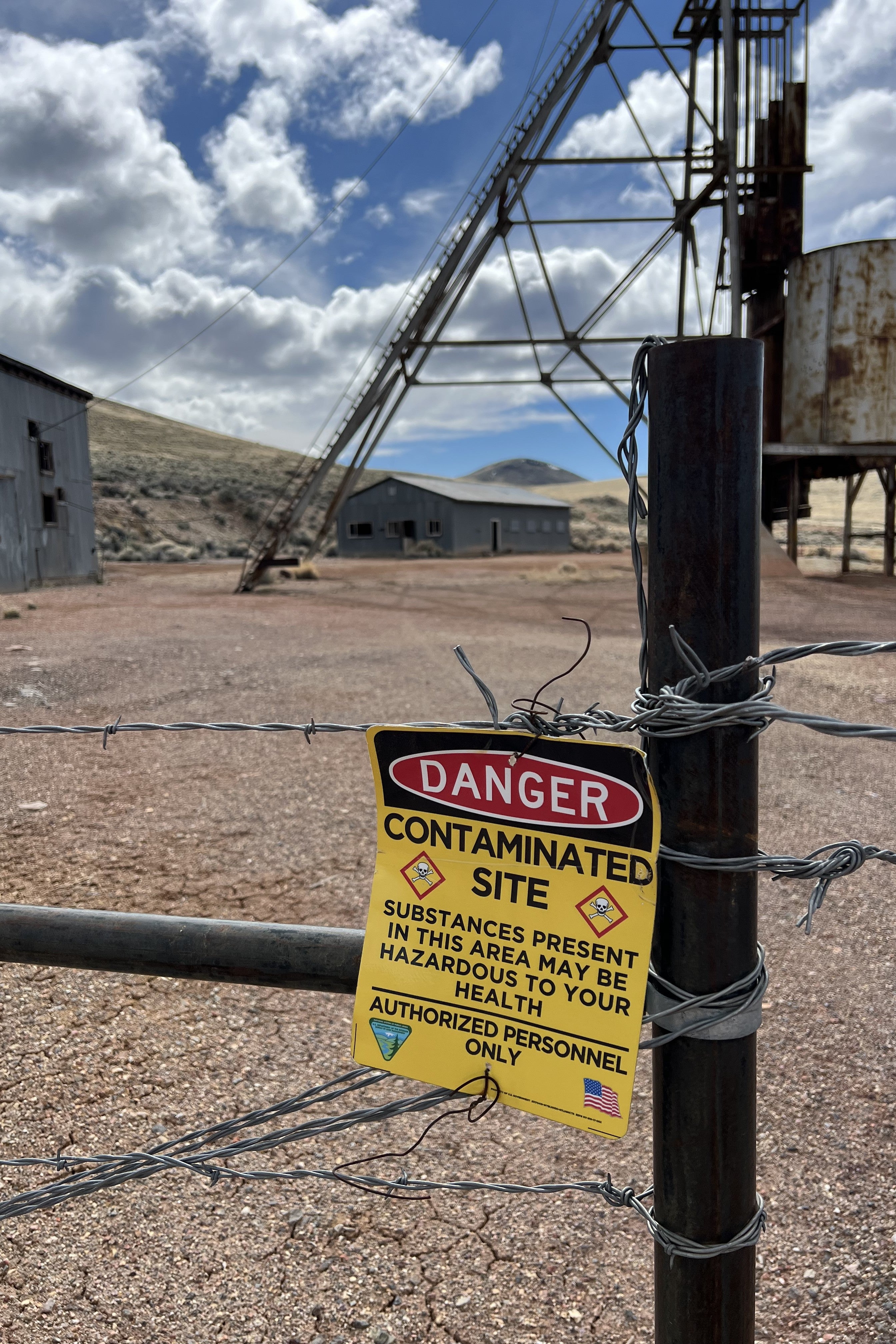 Sign at a former mine that reads "Danger: Contaminated Site"