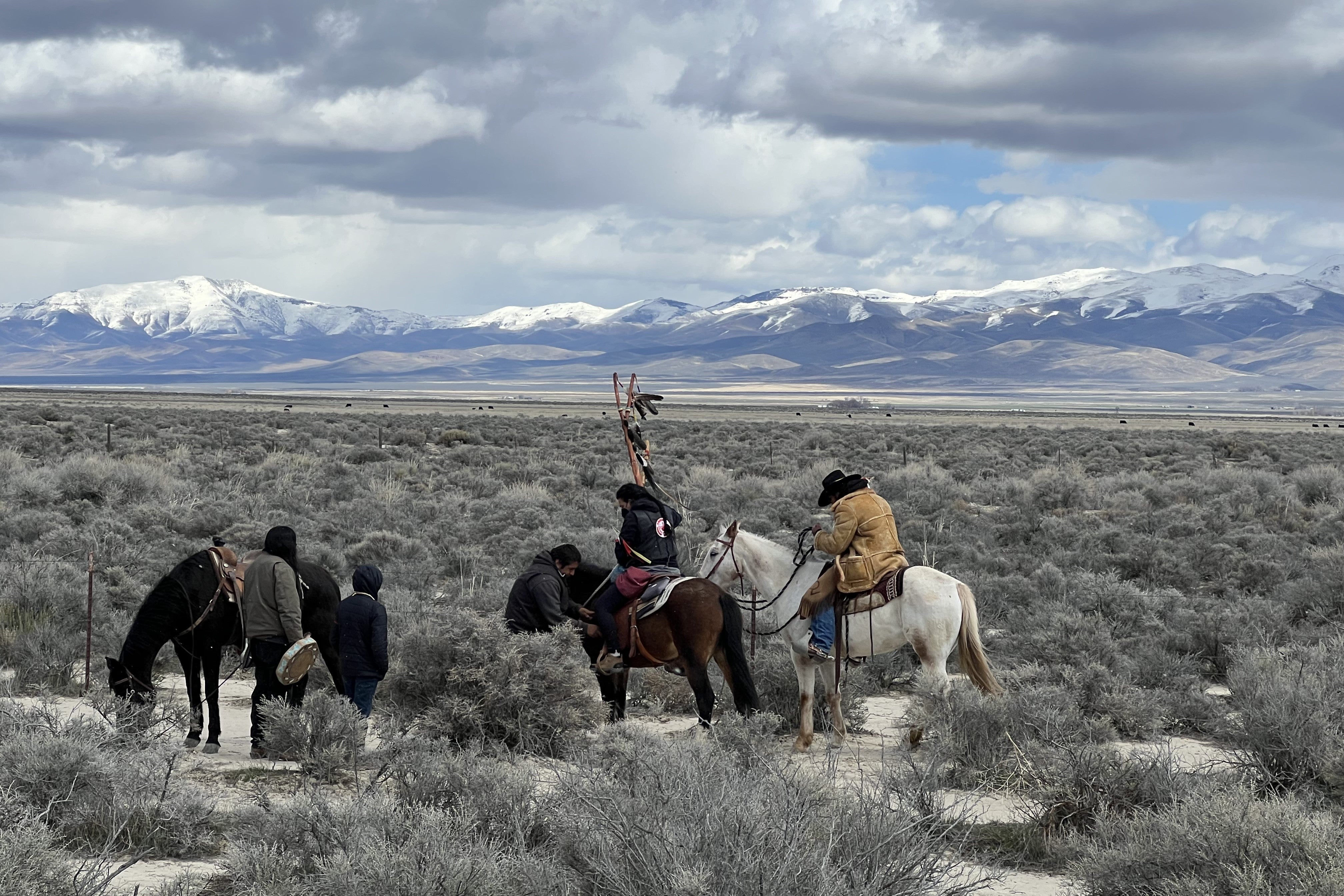Numu/Nuwu and Newe prayer horse riders pictured in front of the mountain range approaching Peehee Mu’huh