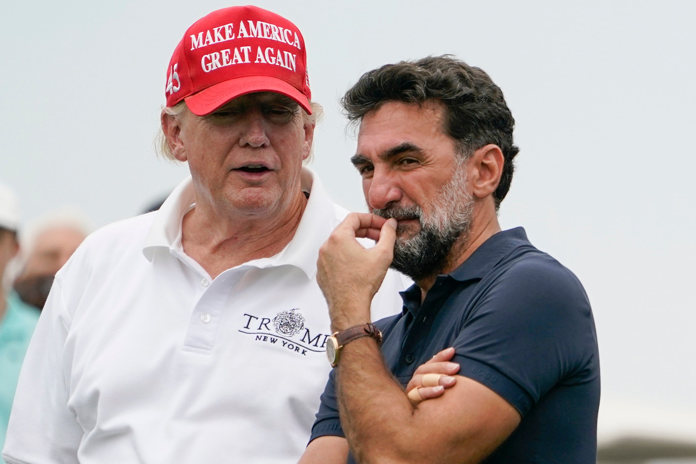 US President Donald Trump, left, talks with Yasir Al-Rumayyan, governor of Saudi Arabia's Public Investment Fund, during the Bedminster Invitational LIV Golf tournament in Bedminster, New Jersey, July 29, 2022. 