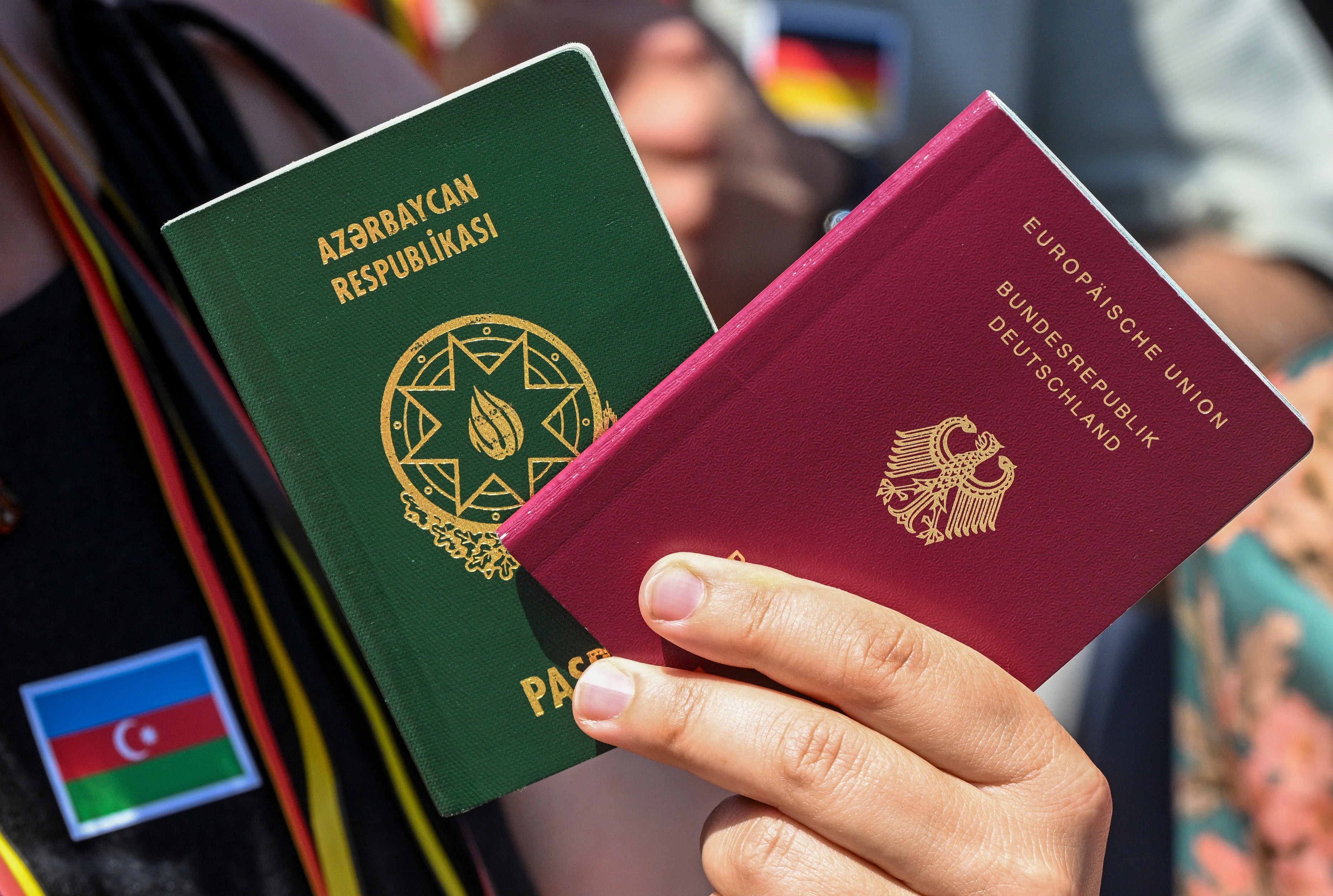 A citizen shows their German and Turkish passports in support of legal recognition for dual citizenship, Berlin, Germany, June 27, 2024.