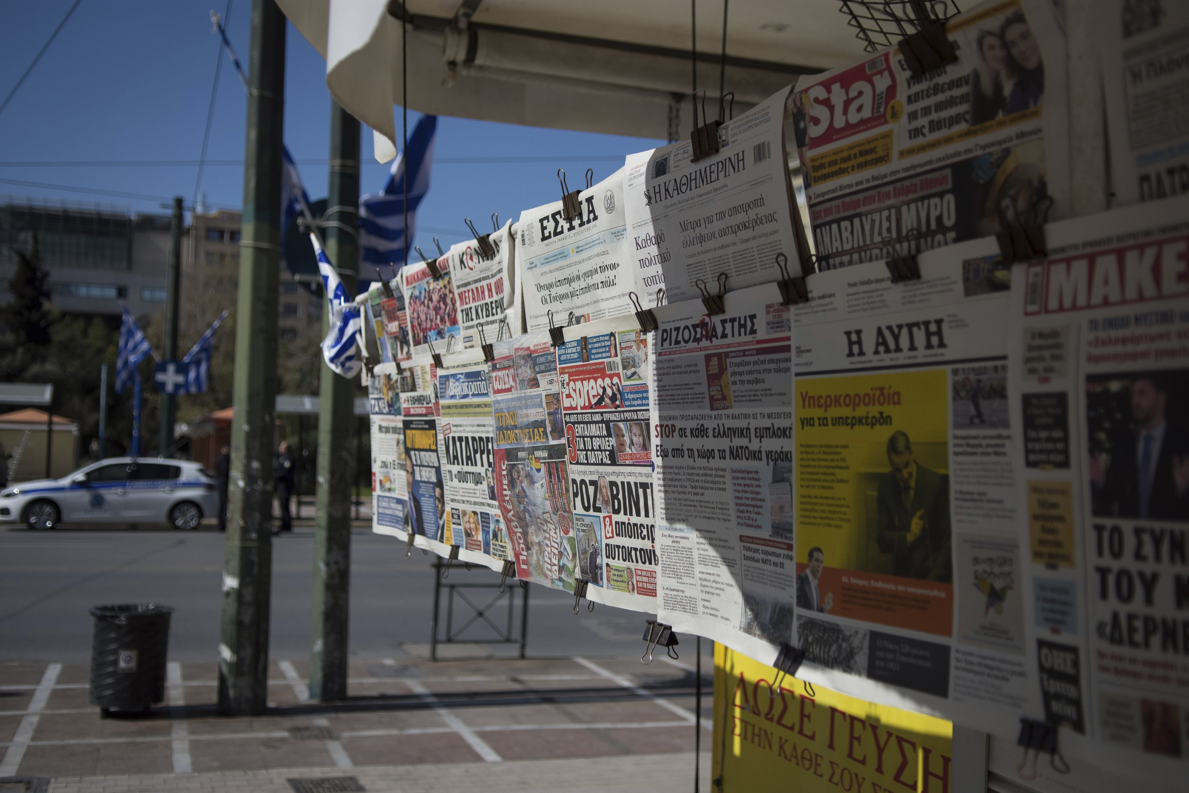 Newspapers hanging on a kiosk 