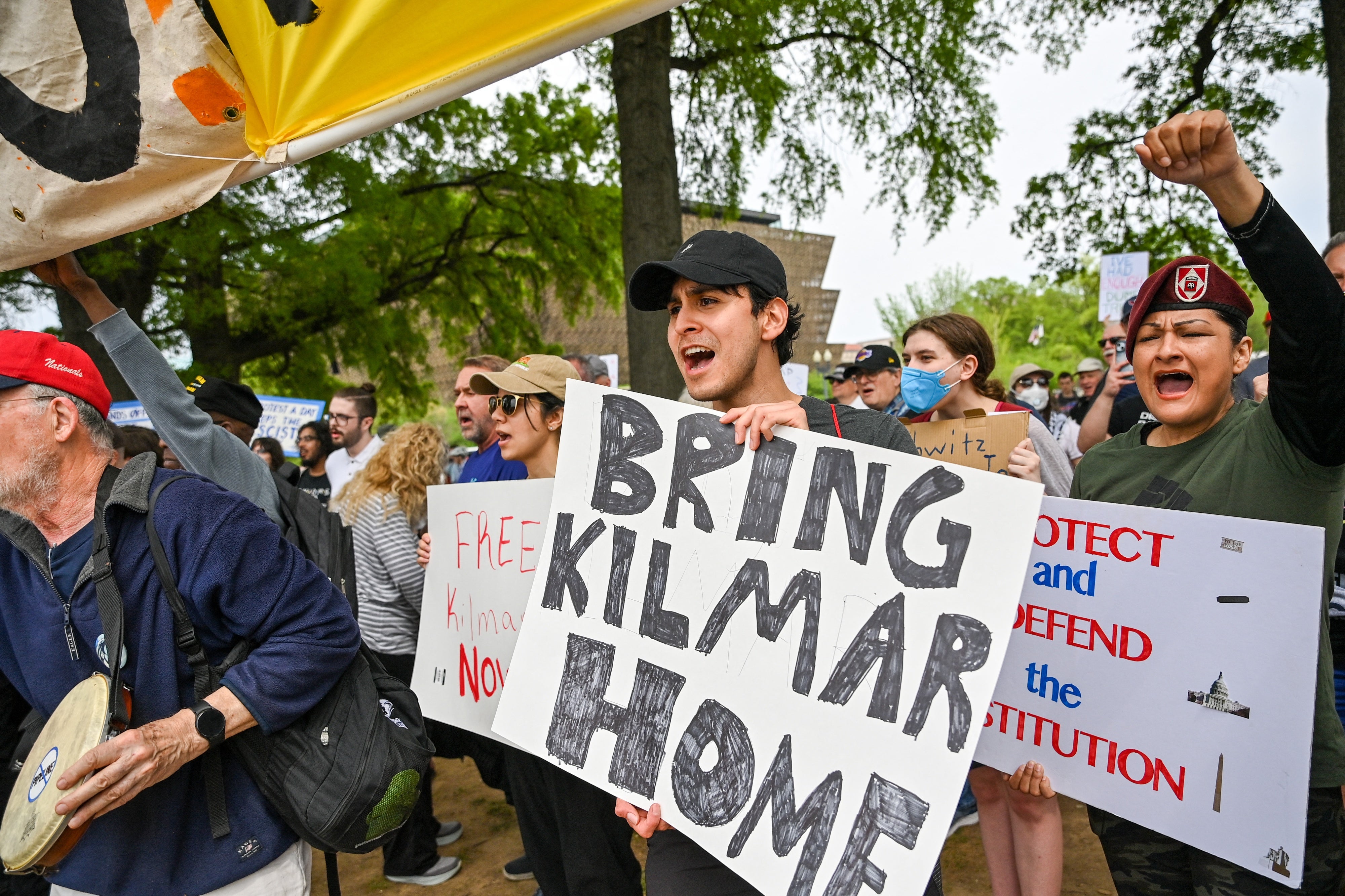 Protestors hold signs saying "Bring Kilmar Home" during a Free Kilmar Abrego and Hands Off protest. 