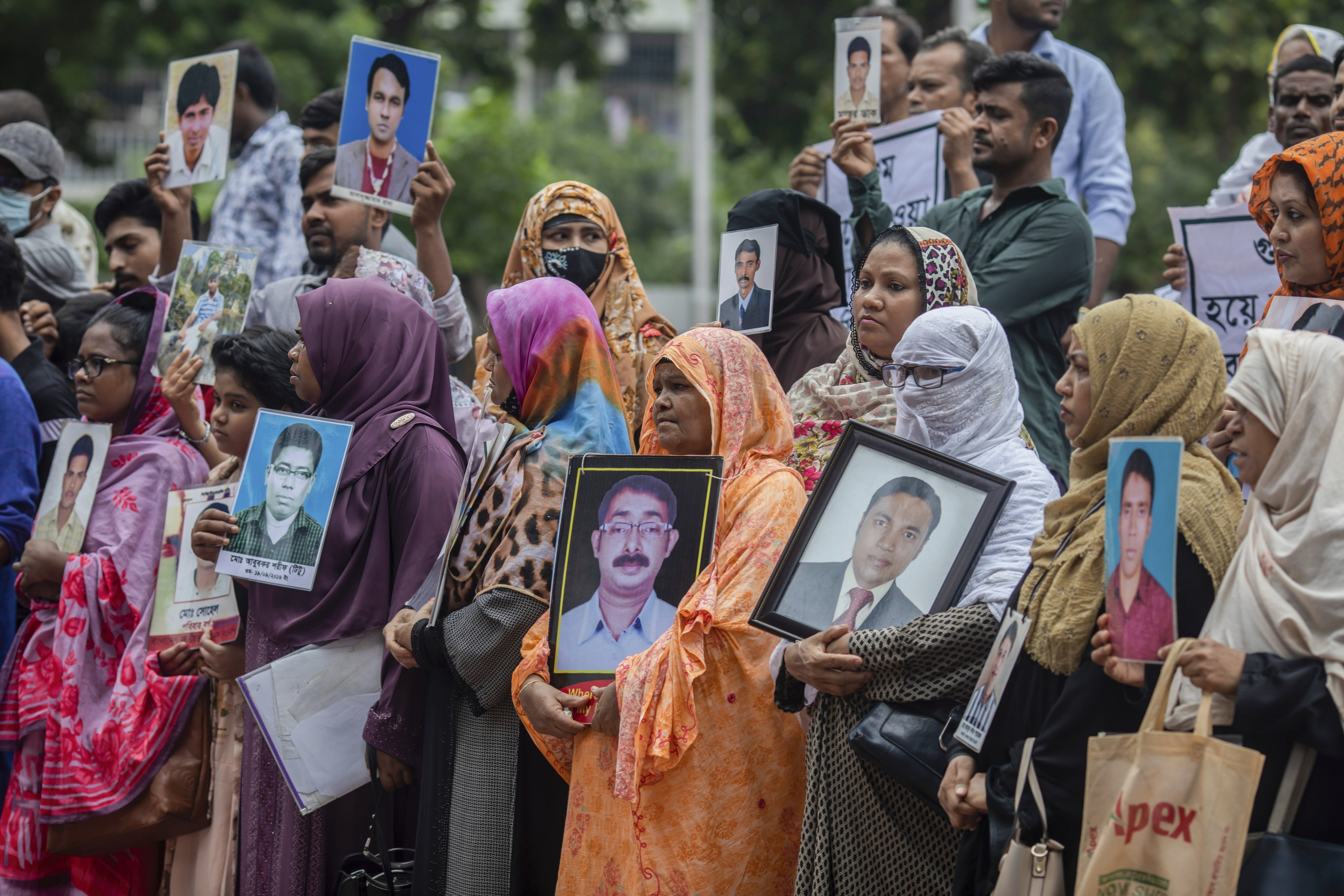 Family members of victims of enforced disappearance allegedly committed by government agencies during the rule of the Awami League hold portraits of their relatives while asking for their return in front of the Shaheed Minar, Bangladesh, August 11, 2024. 