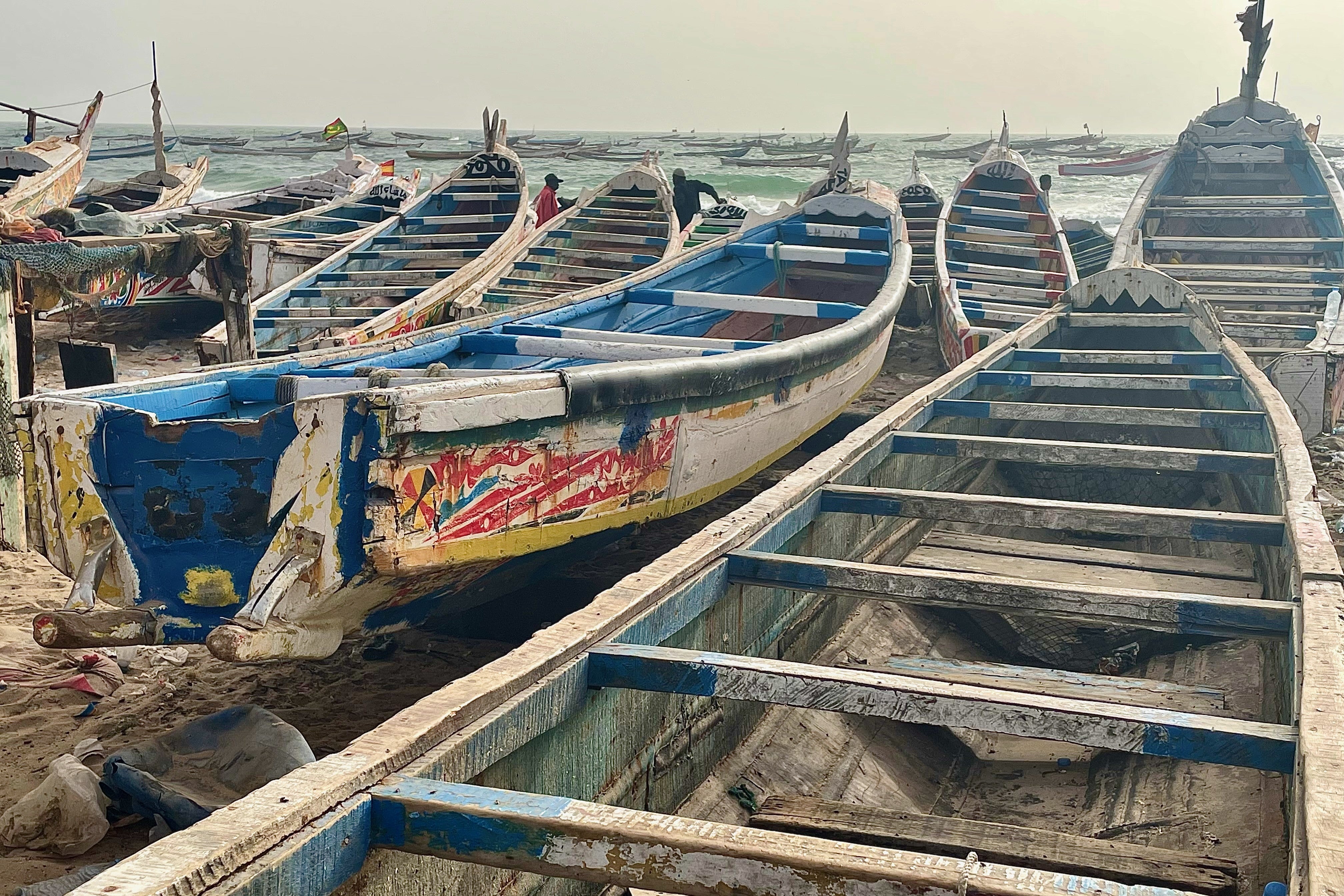 Wooden boats known as pirogues, traditionally used for fishing in Mauritania and West Africa, on the shores of Nouakchott, Mauritania