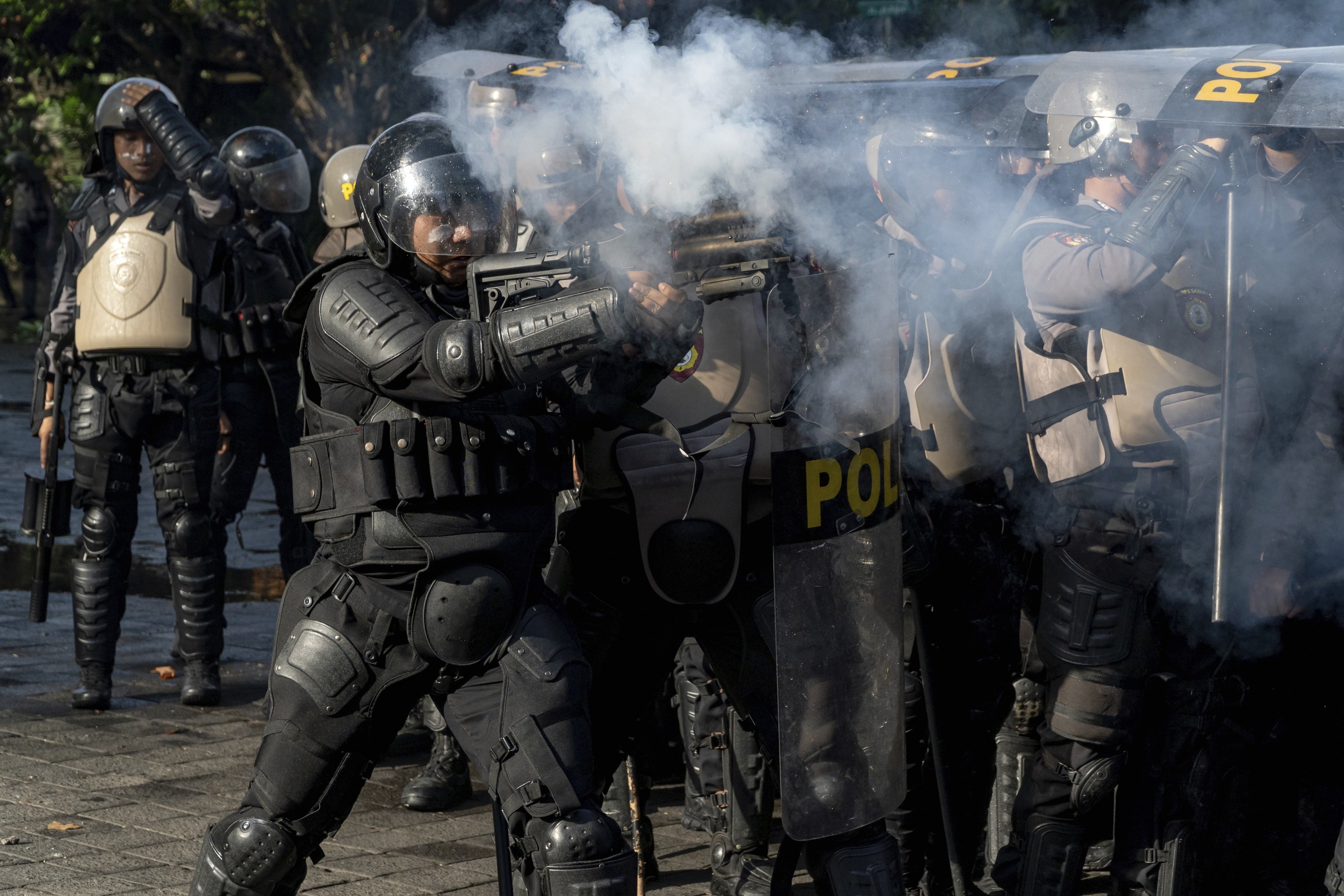 An Indonesian police officer fires tear gas during a demonstration in Jakarta, Indonesia, August 28, 2025. 
