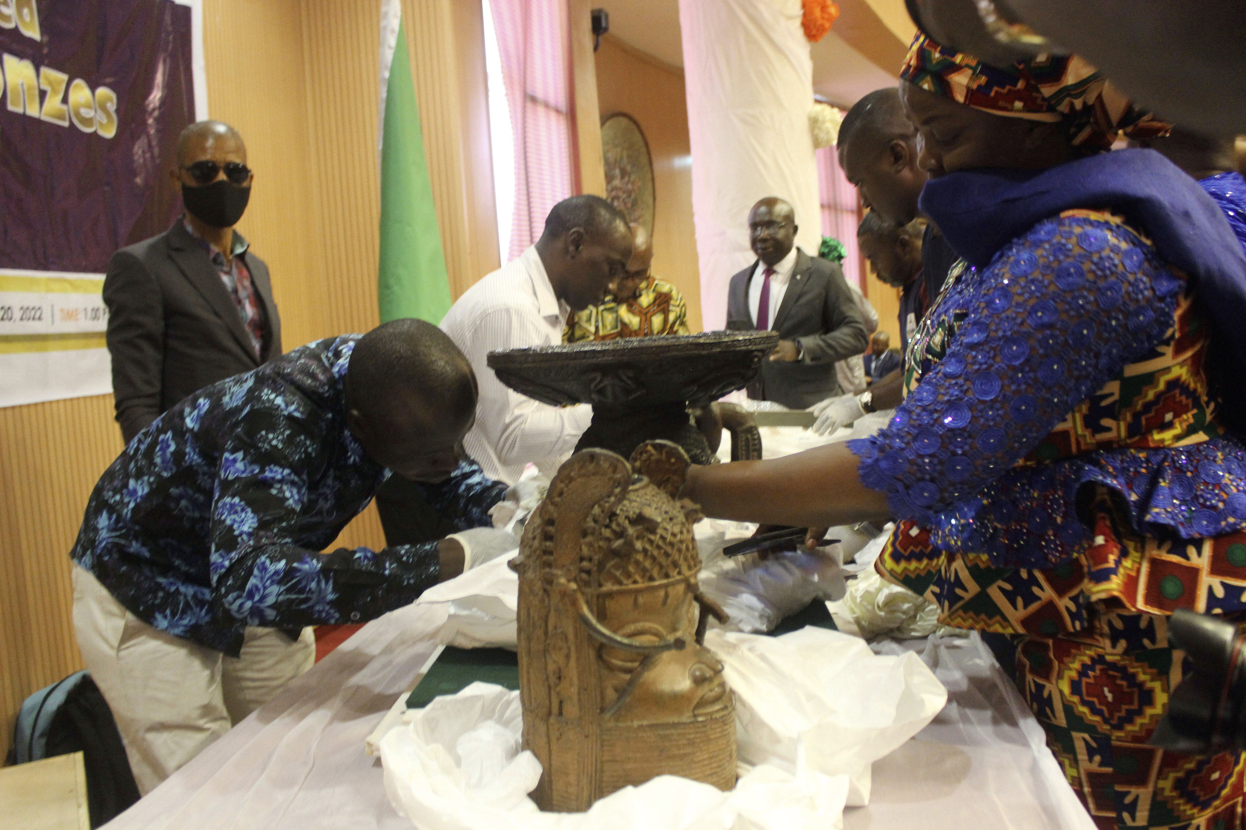 Benin bronzes looted in the past and returned to Nigeria by Germany are examined during a handing over ceremony in Abuja, December 20, 2022. 