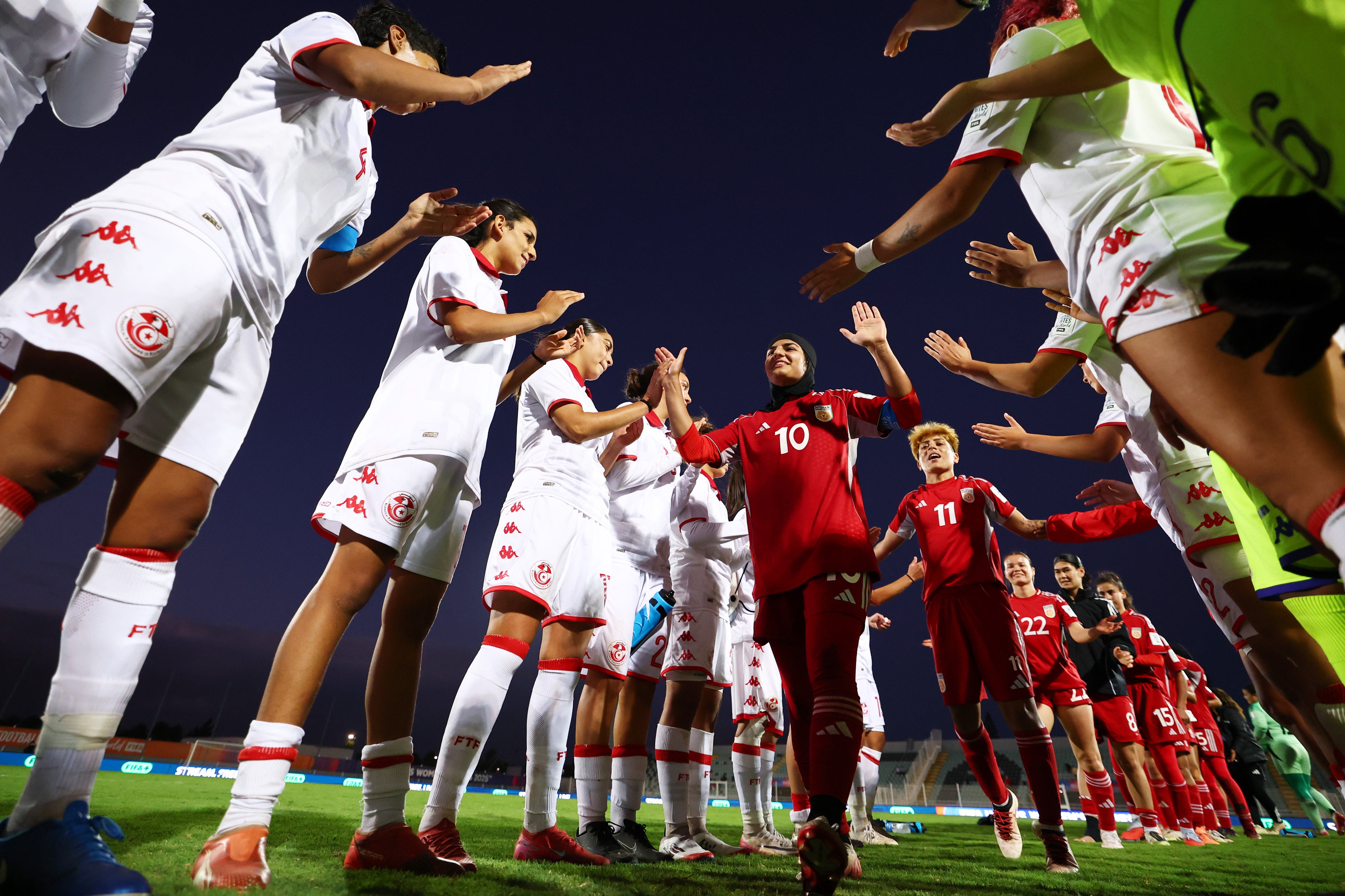 Players of Afghan Women's United football team receive support from Tunisian players after the FIFA Unites: Women's Series 2025 on October 29 in Casablanca, Morocco. 