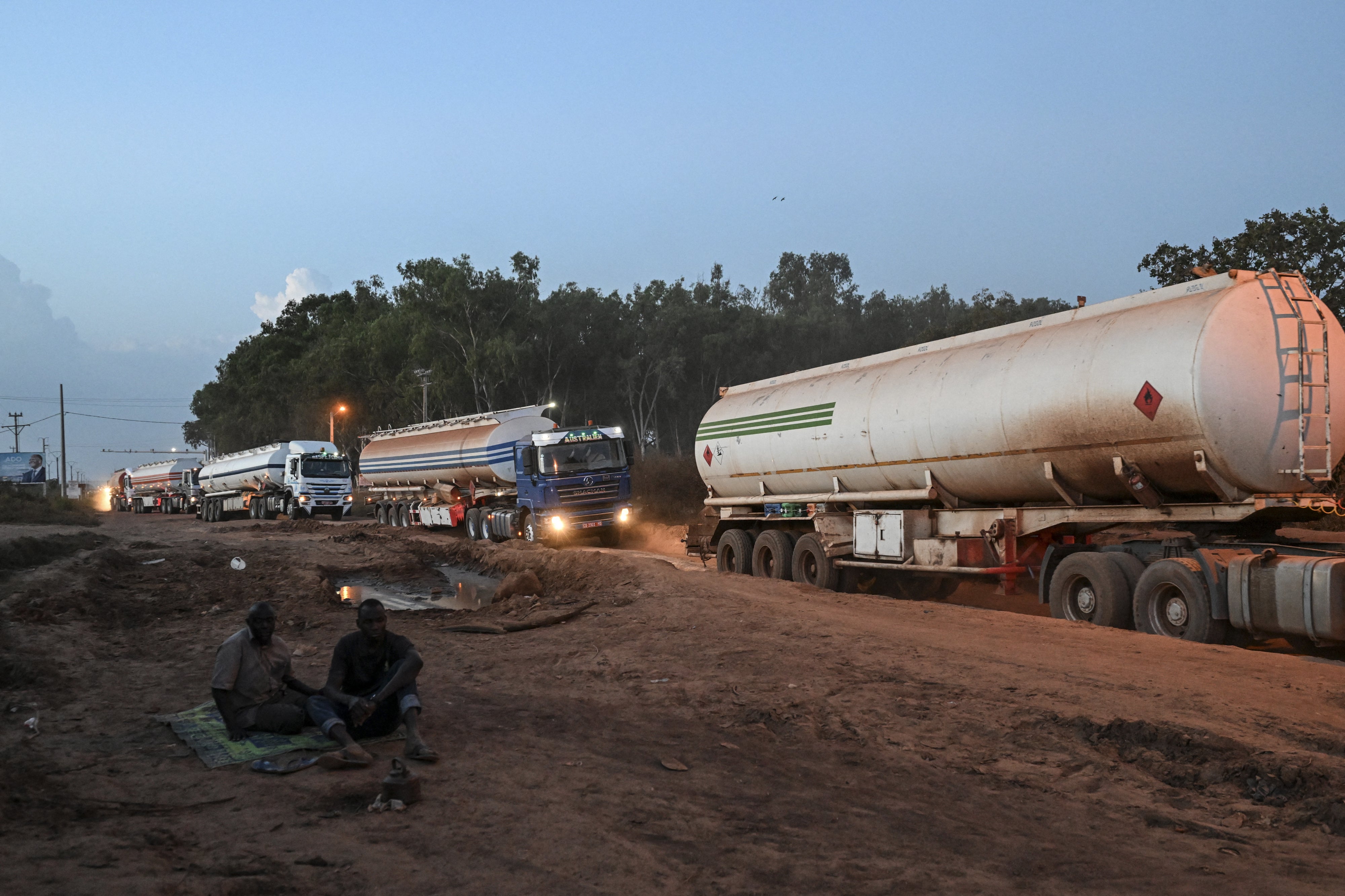 Malian tanker trucks drive at the entrance of Boundiali, northern Côte d'Ivoire, on the way to Yamoussoukro and Abidjan to load oil, October 30, 2025.