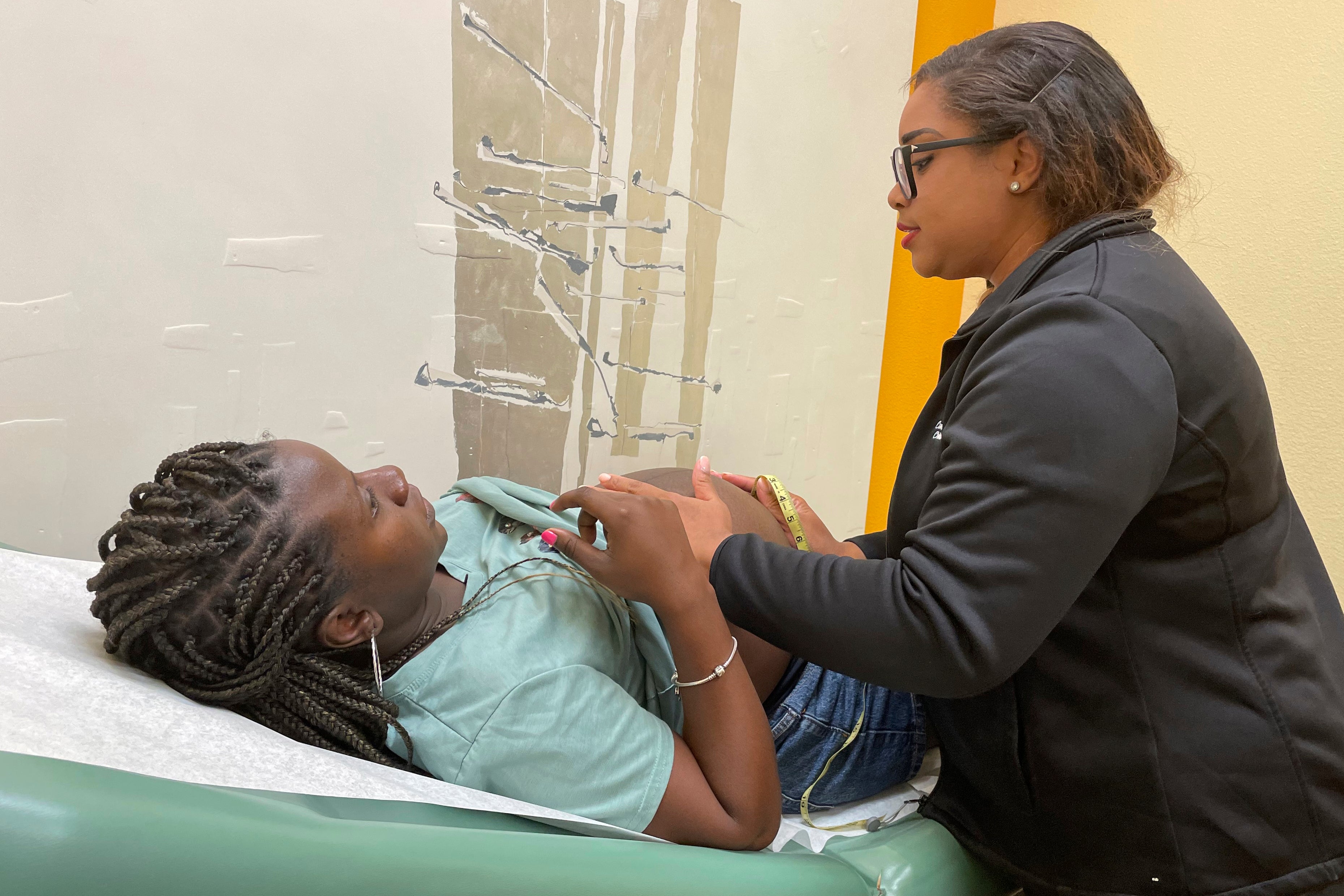 Midwife Celena Brown of Commonsense Childbirth in Florida, examines a patient during a pregnancy checkup in Winter Garden, Florida, US, June 25, 2024.