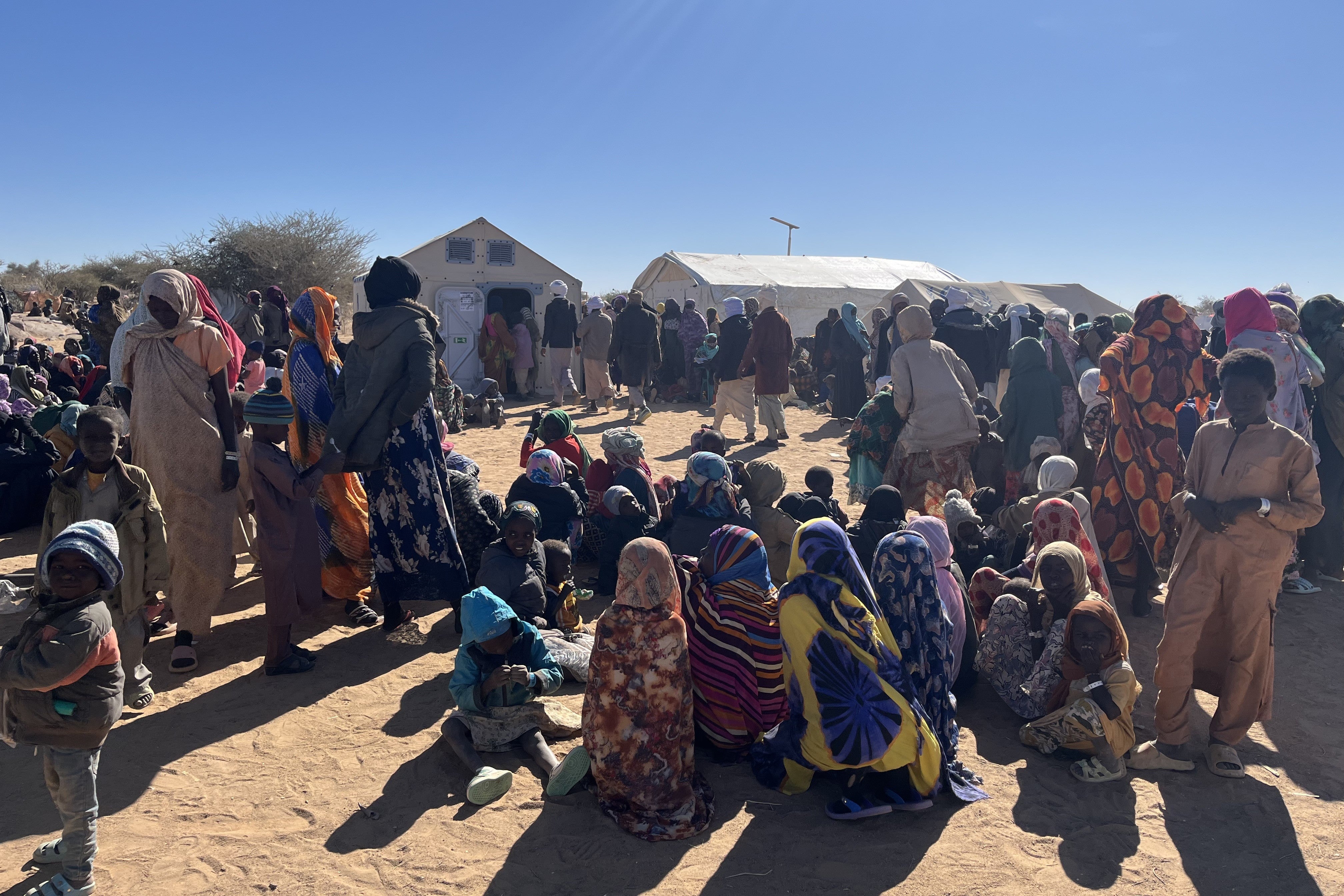 Refugees queue for registration at a camp