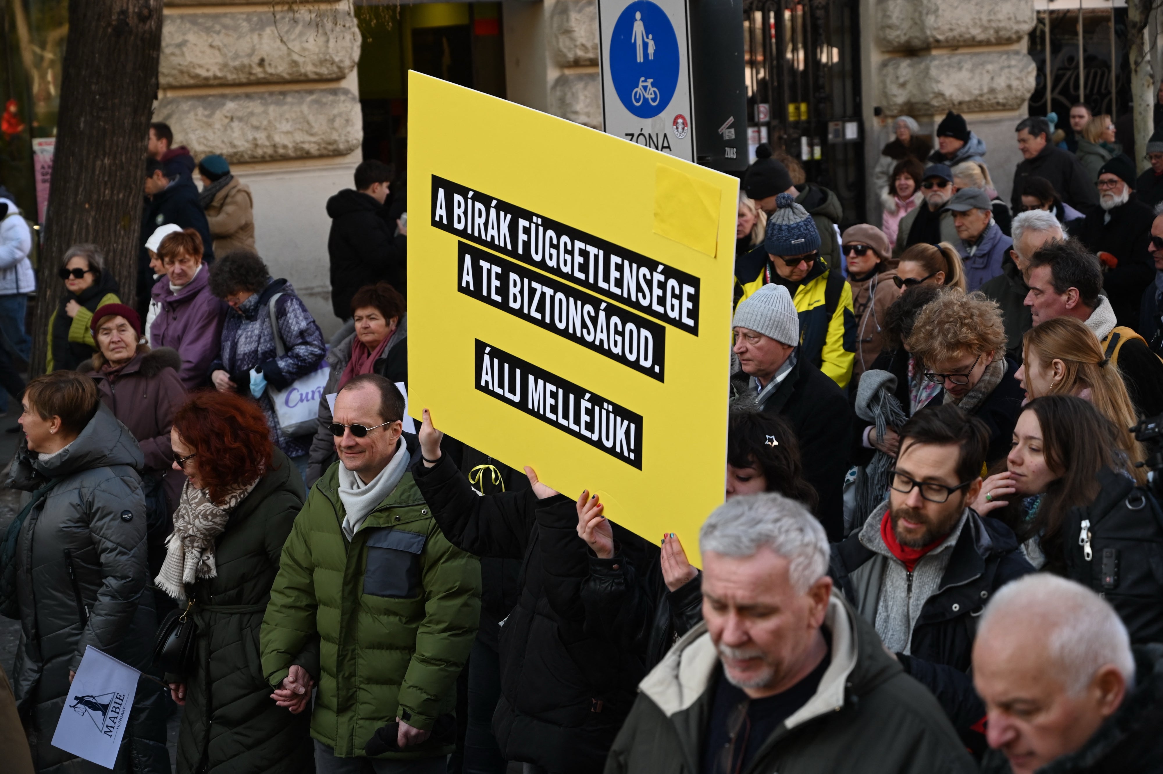 Participants hold a placard reading "The independence of the judges is your security - Stand by them!" as Hungarian judges and court employees demonstrate in Budapest, Hungary, on February 22, 2025, for independence of the judiciary, rule of law, and freedom of expression of judges.