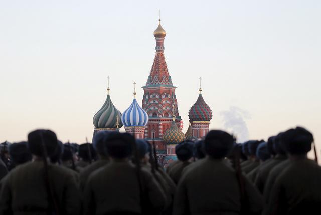 Russian servicemen, dressed in historical uniforms, line up as they take part in a military parade rehearsal in front of St. Basil's Cathedral in Red Square in central Moscow, Russia, November 6, 2015.
