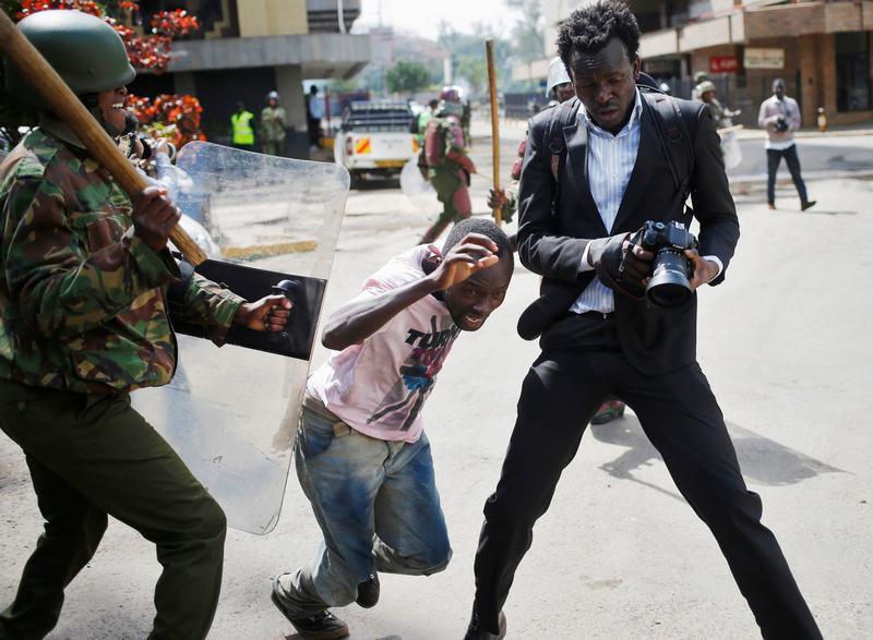 A Kenyan policeman beats a protester during clashes in Nairobi, Kenya May 16, 2016.