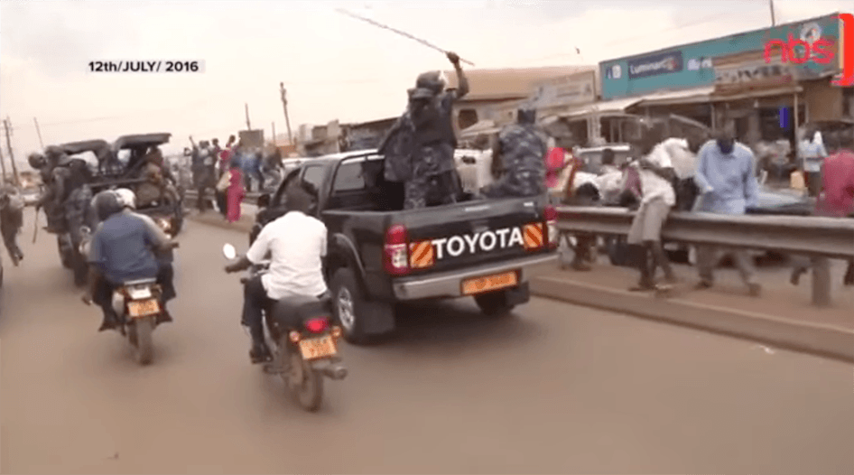 A still from video shows security forces caning and beating supporters of Dr. Kizza Besigye as they gathered to see him on his way home from prison, following his bail.