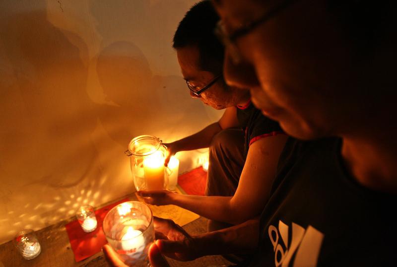 Anti-death penalty activists place candles outside Changi prison in Singapore December 2, 2005.