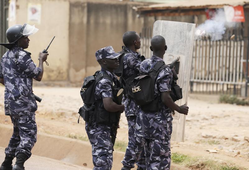 A policemen fires a teargas canister in front of opposition leader Kizza Besigye's office in Kampala, Uganda, February 19, 2016.